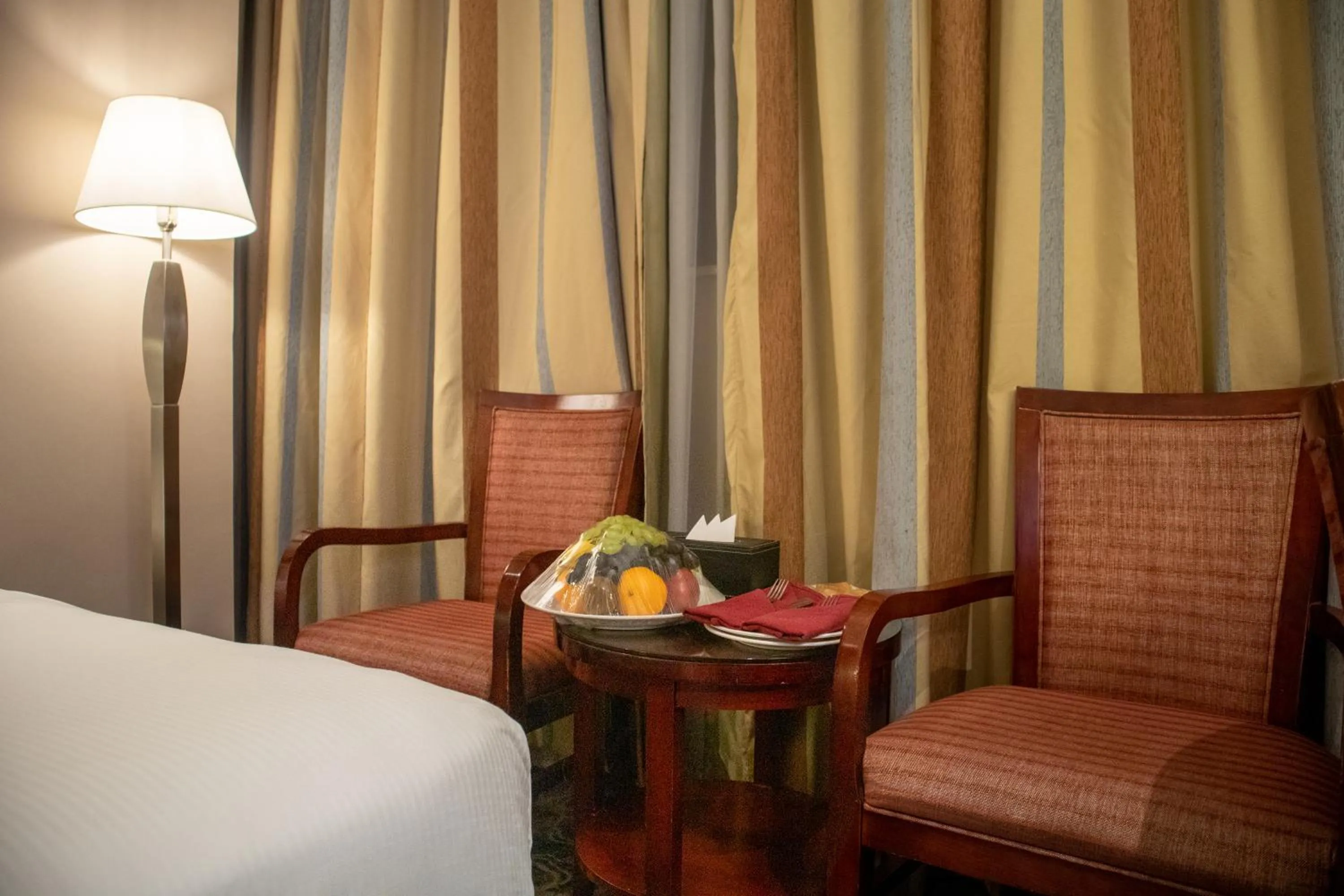 Seating area, Bed in Emaar Royal Hotel