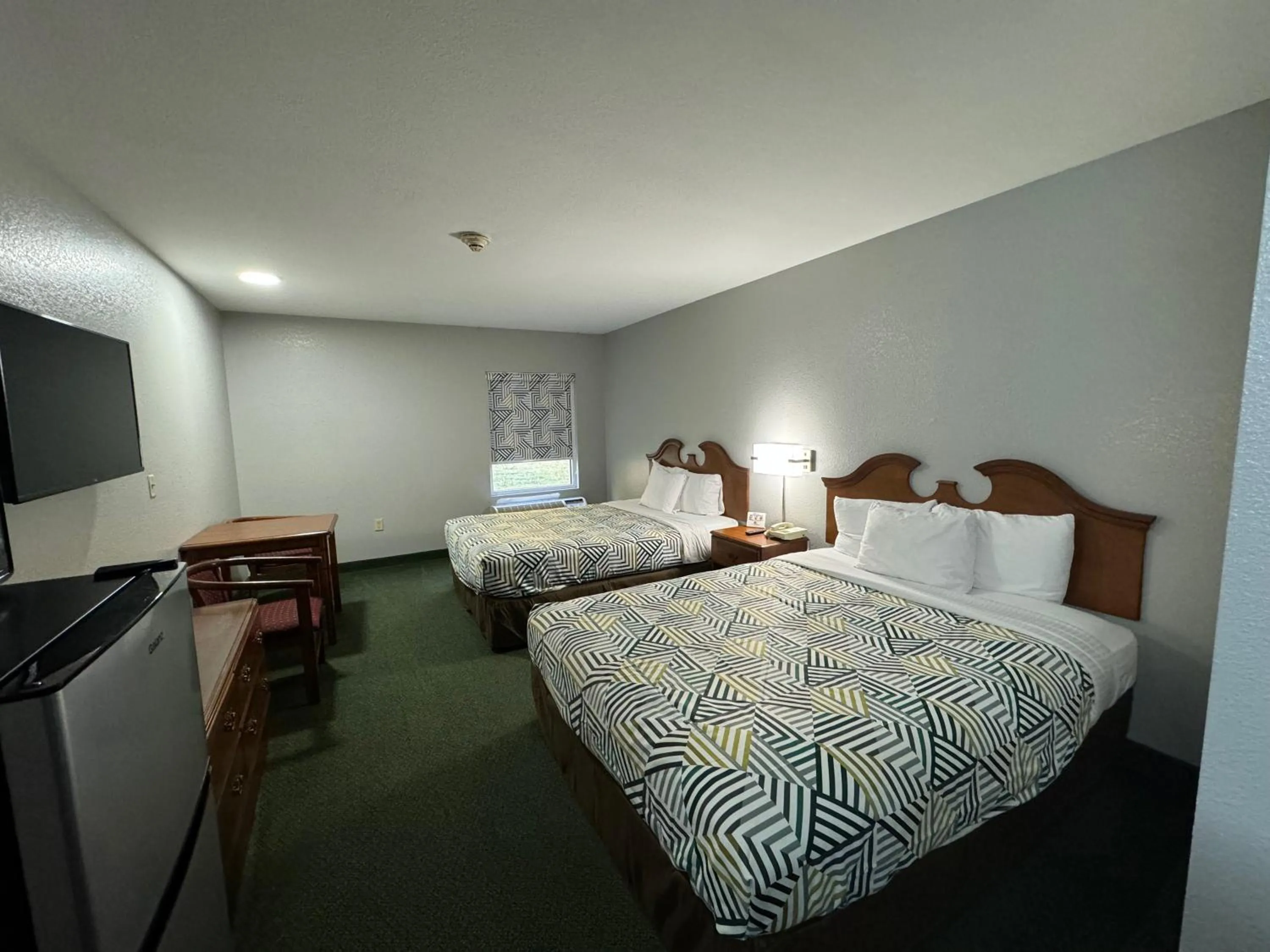 Bed in Star City Inn & Suites