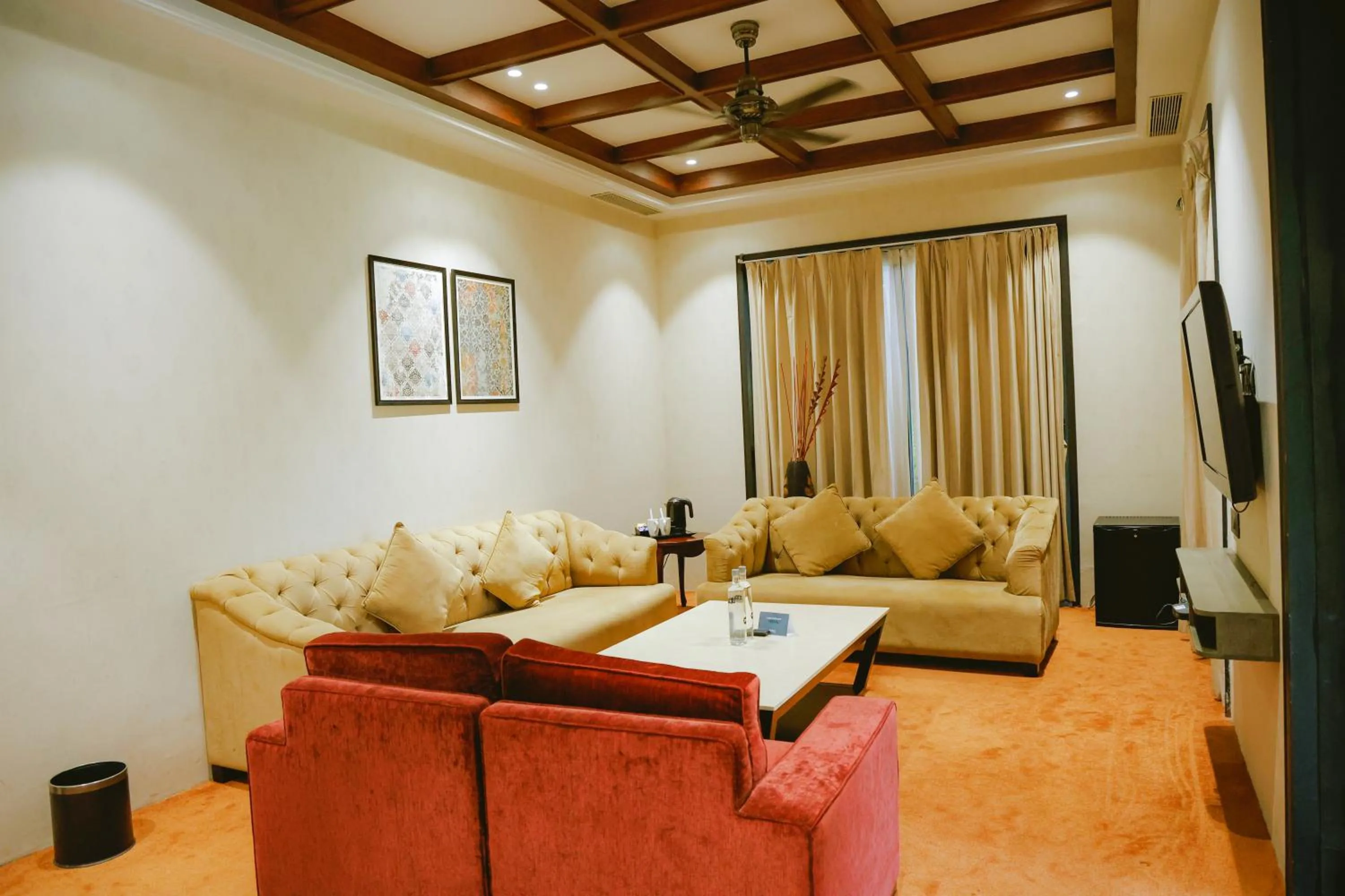 Communal lounge/ TV room, Bed in Radisson Resort & Spa Kandla