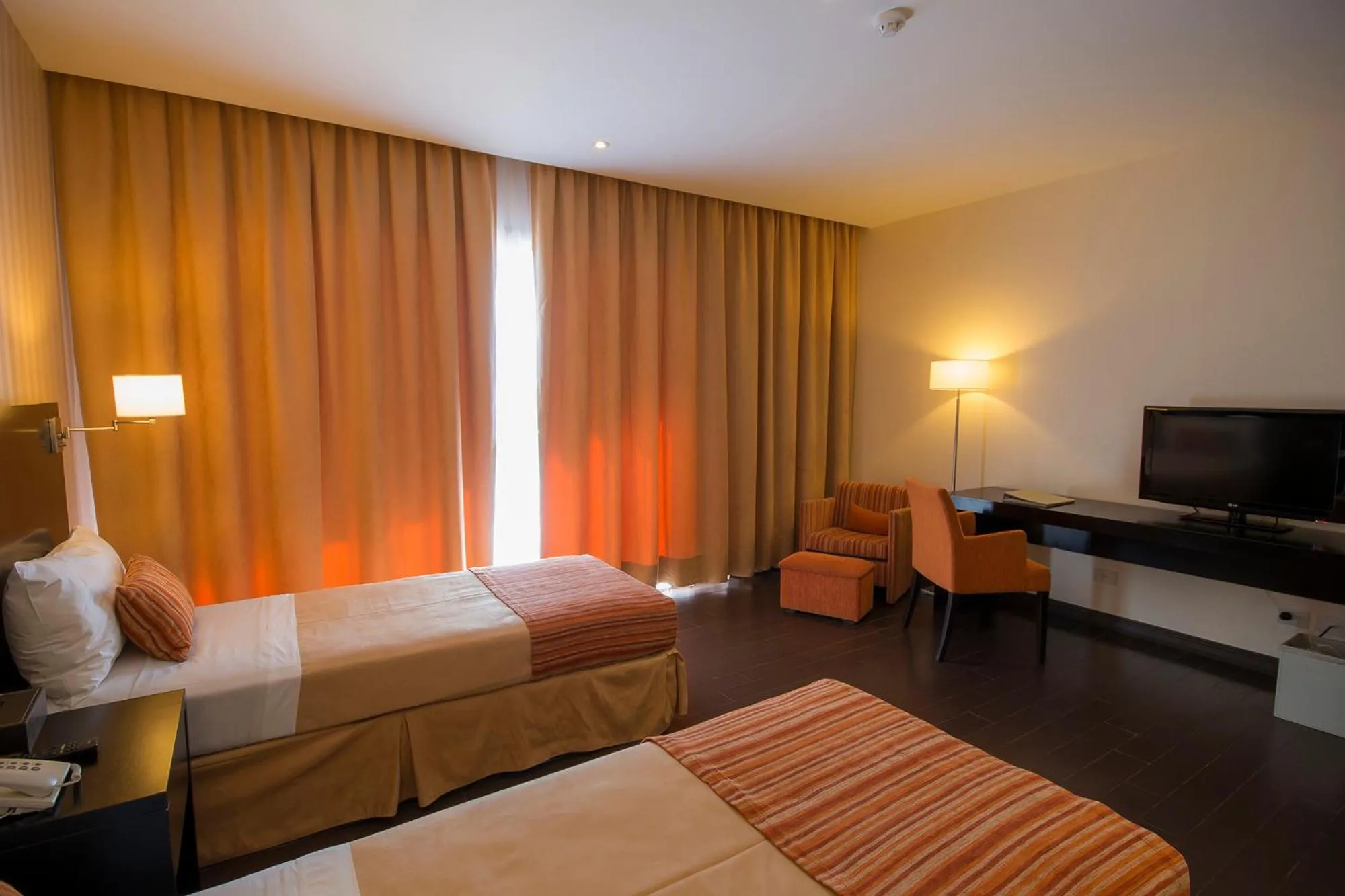 Bed in Grand Crucero Hotel