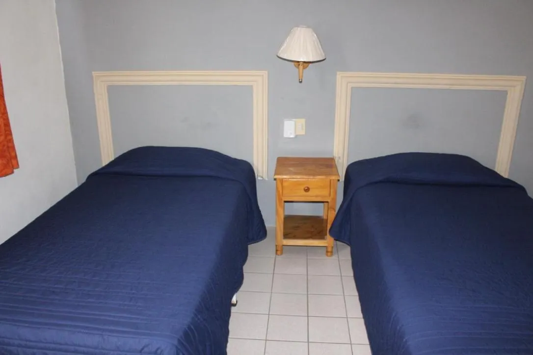 Bed in Hotel y Suites Corita