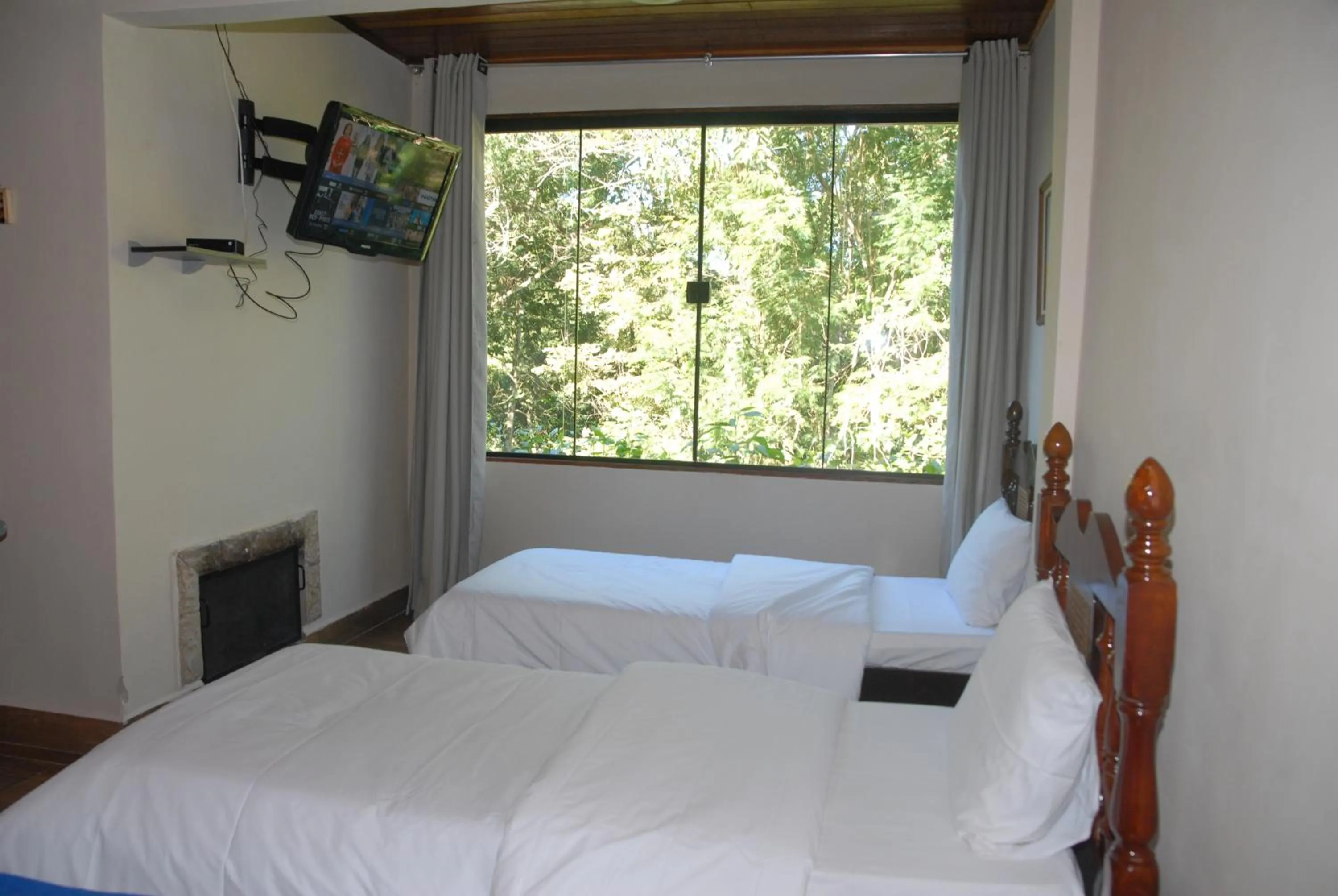 Bed in Pousada Mirante do Penedo