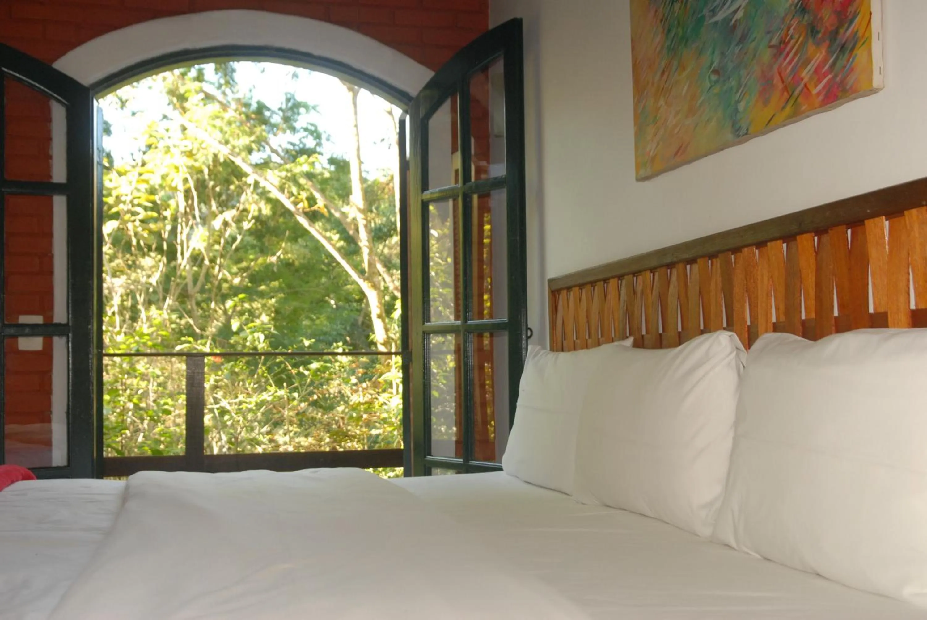 Bed in Pousada Mirante do Penedo