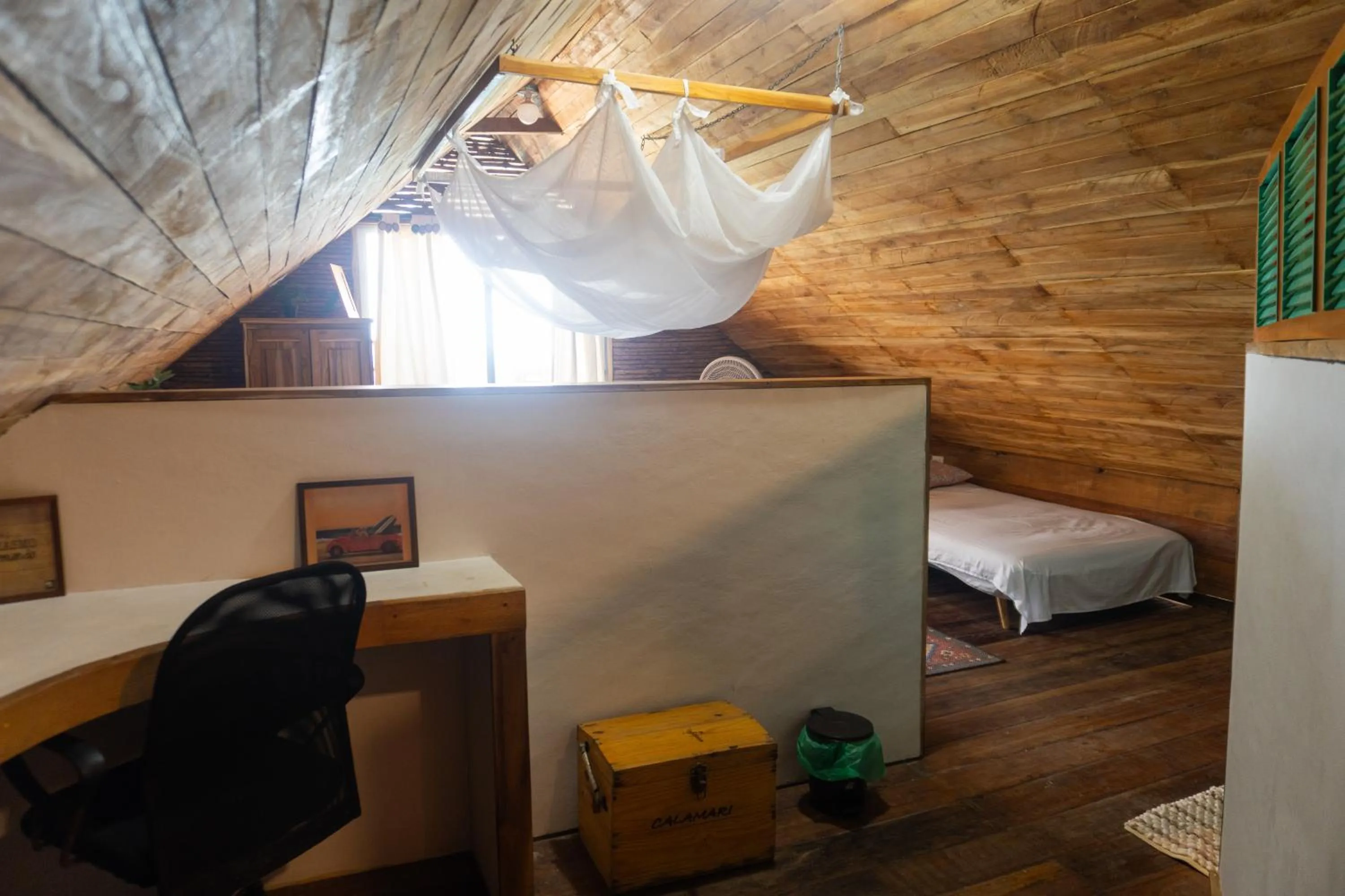 Seating area, Bed in Hotel Calamari Baru