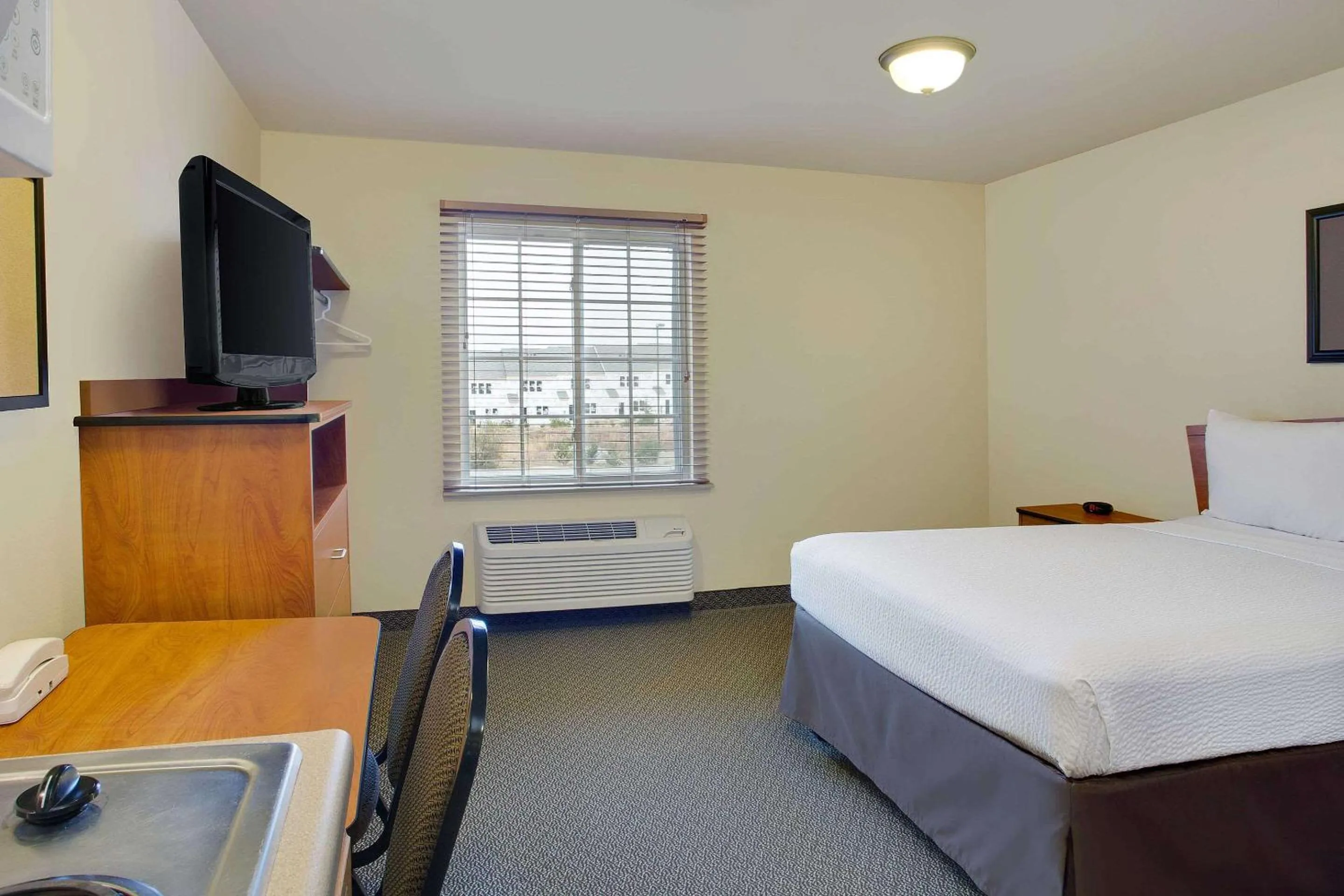 Photo of the whole room, Bed in WoodSpring Suites Raleigh Northeast Wake Forest
