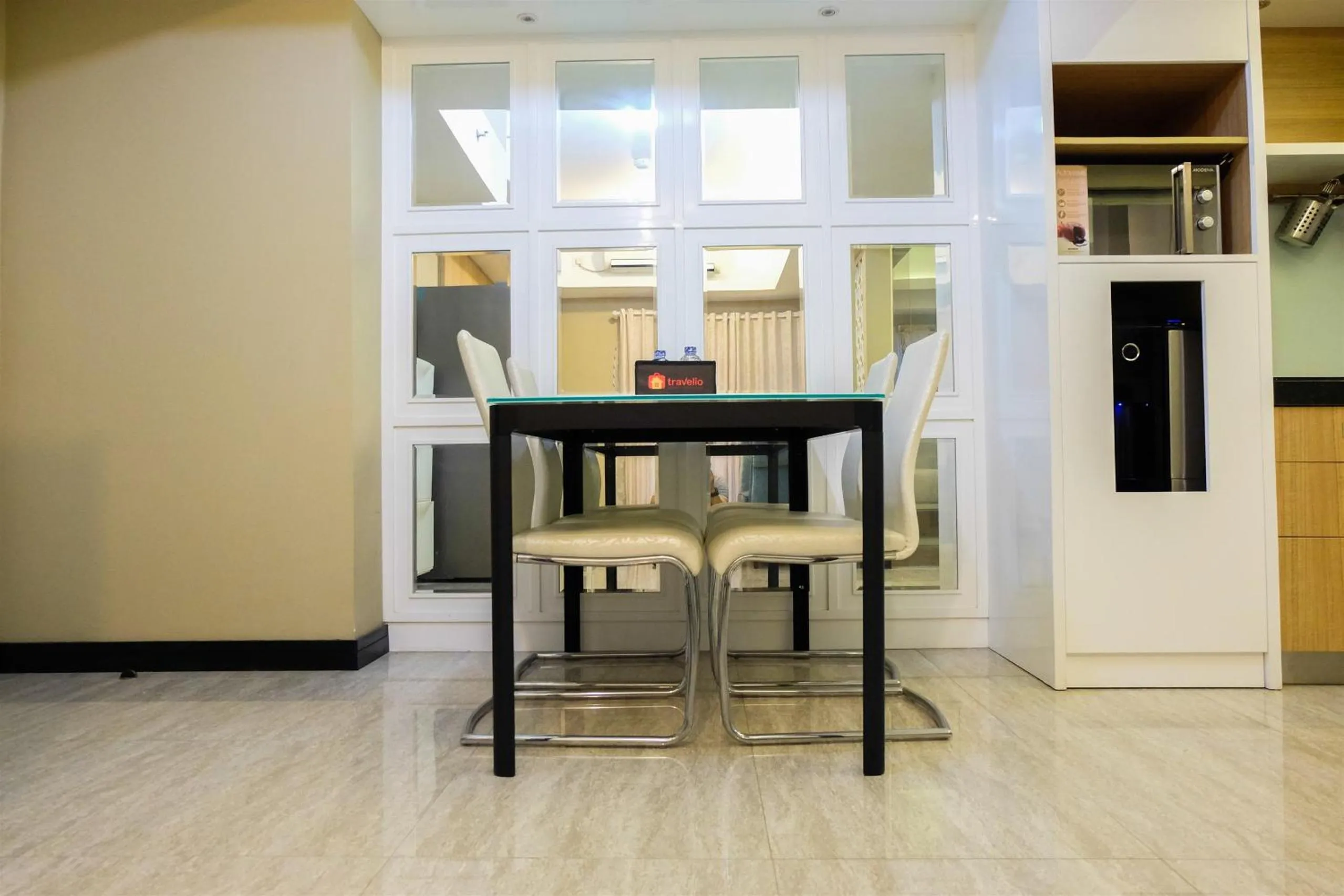 Dining area in Amazing 2BR with City View The Wave Kuningan Apartment By Travelio