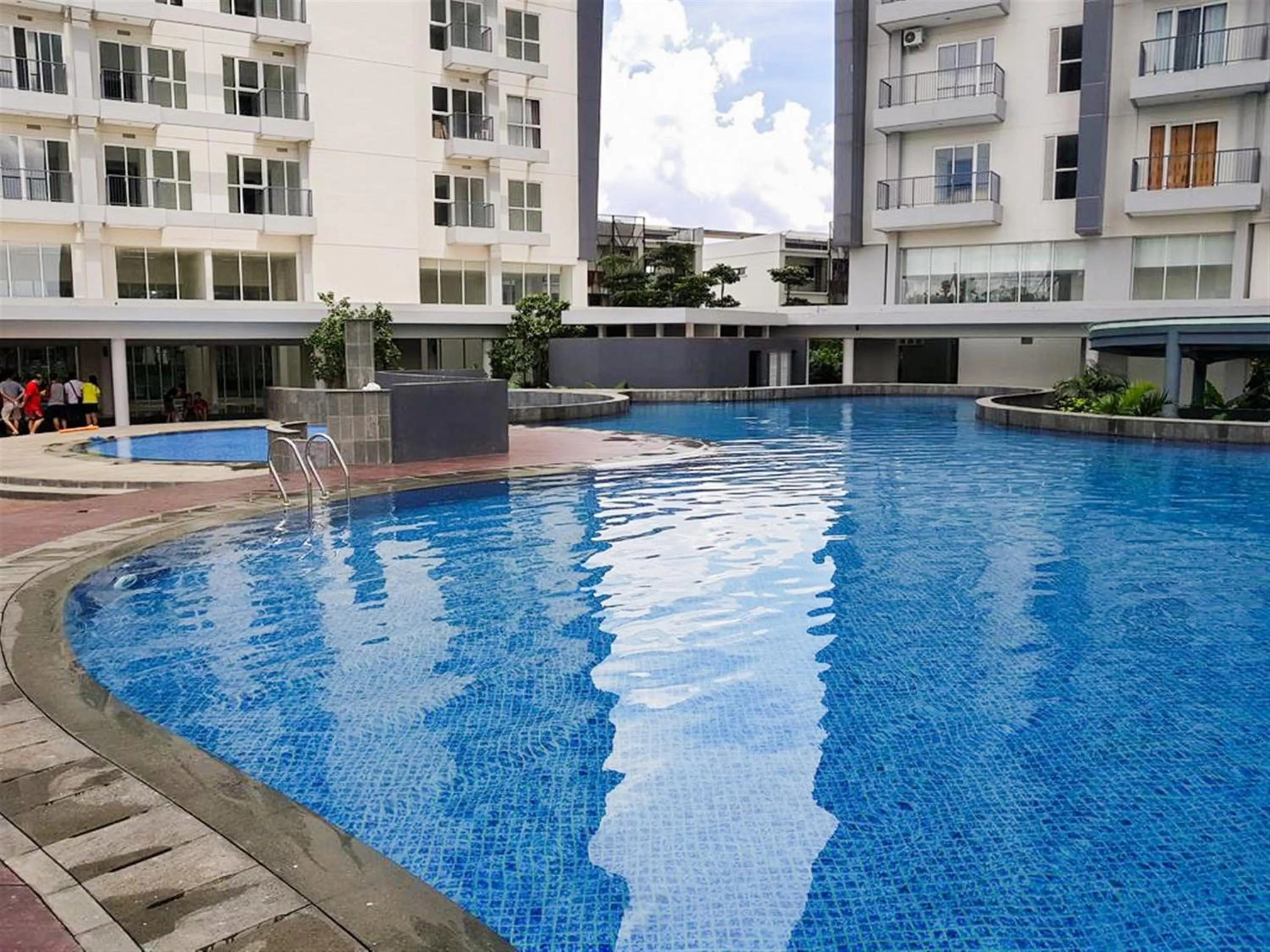 Swimming pool in Exclusive 1BR Casa De Parco Apartment near AEON Mall By Travelio
