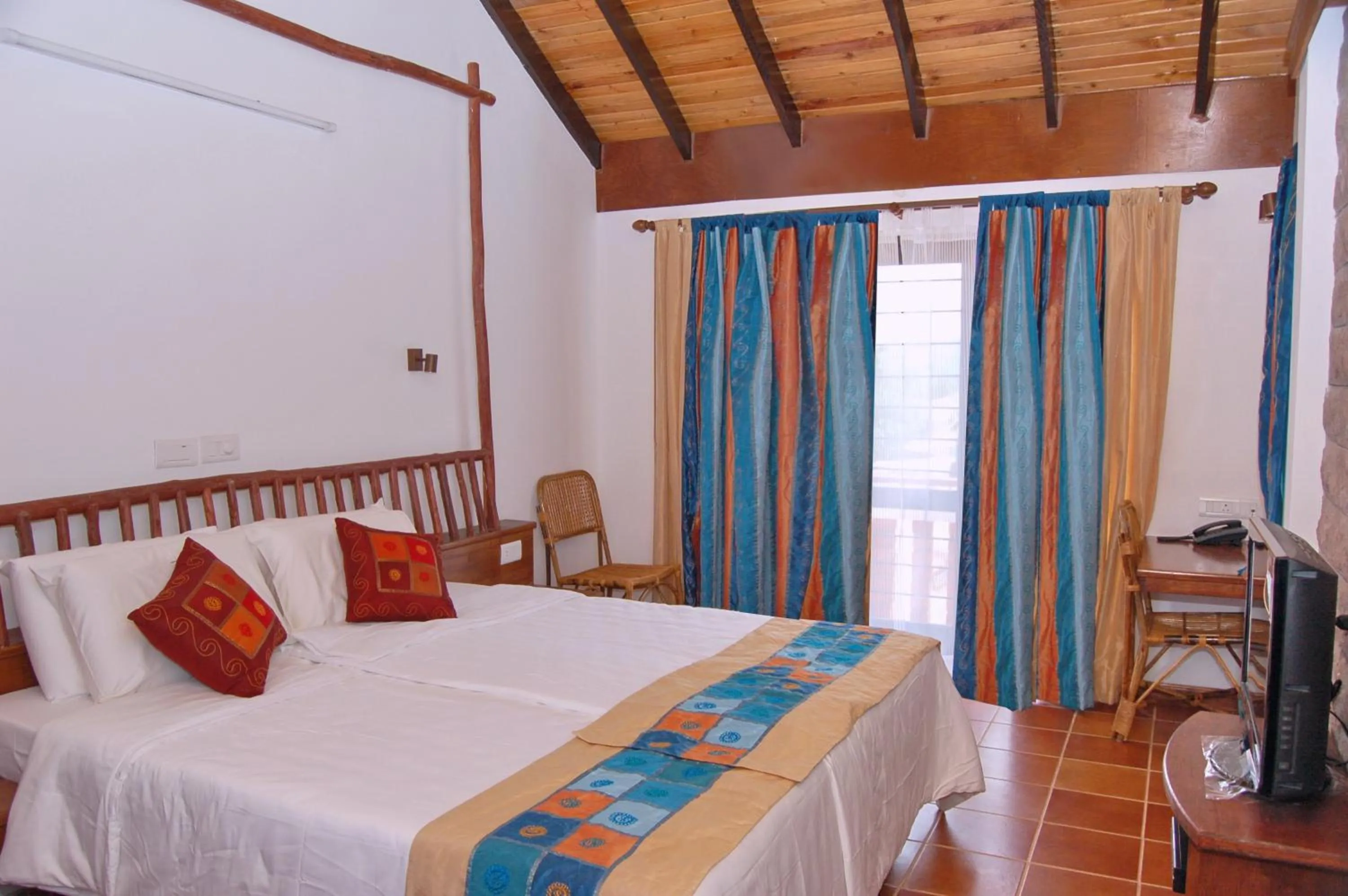 Bedroom in Kadambavanam Ethnic Village Resort