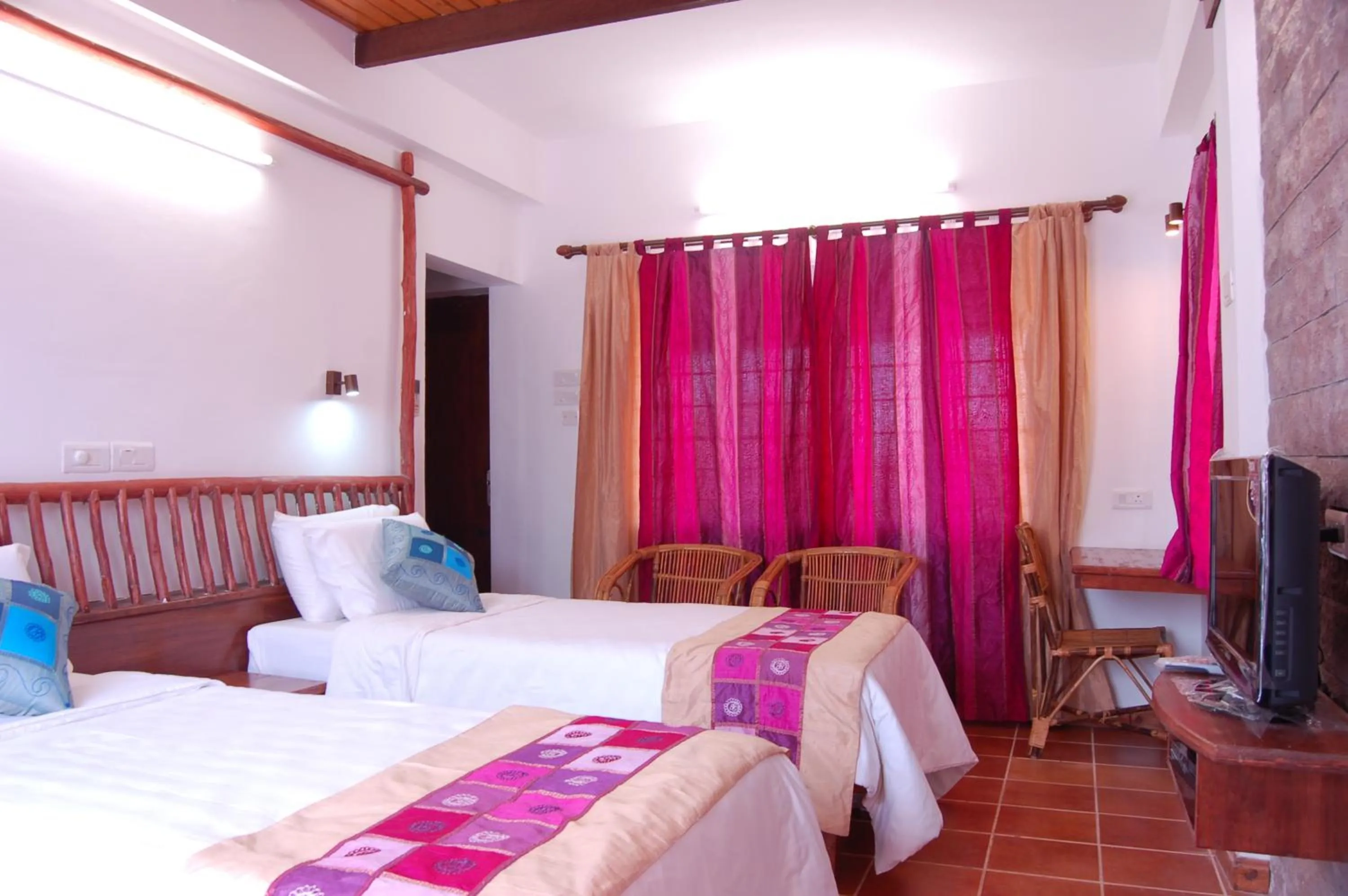 Bedroom in Kadambavanam Ethnic Village Resort