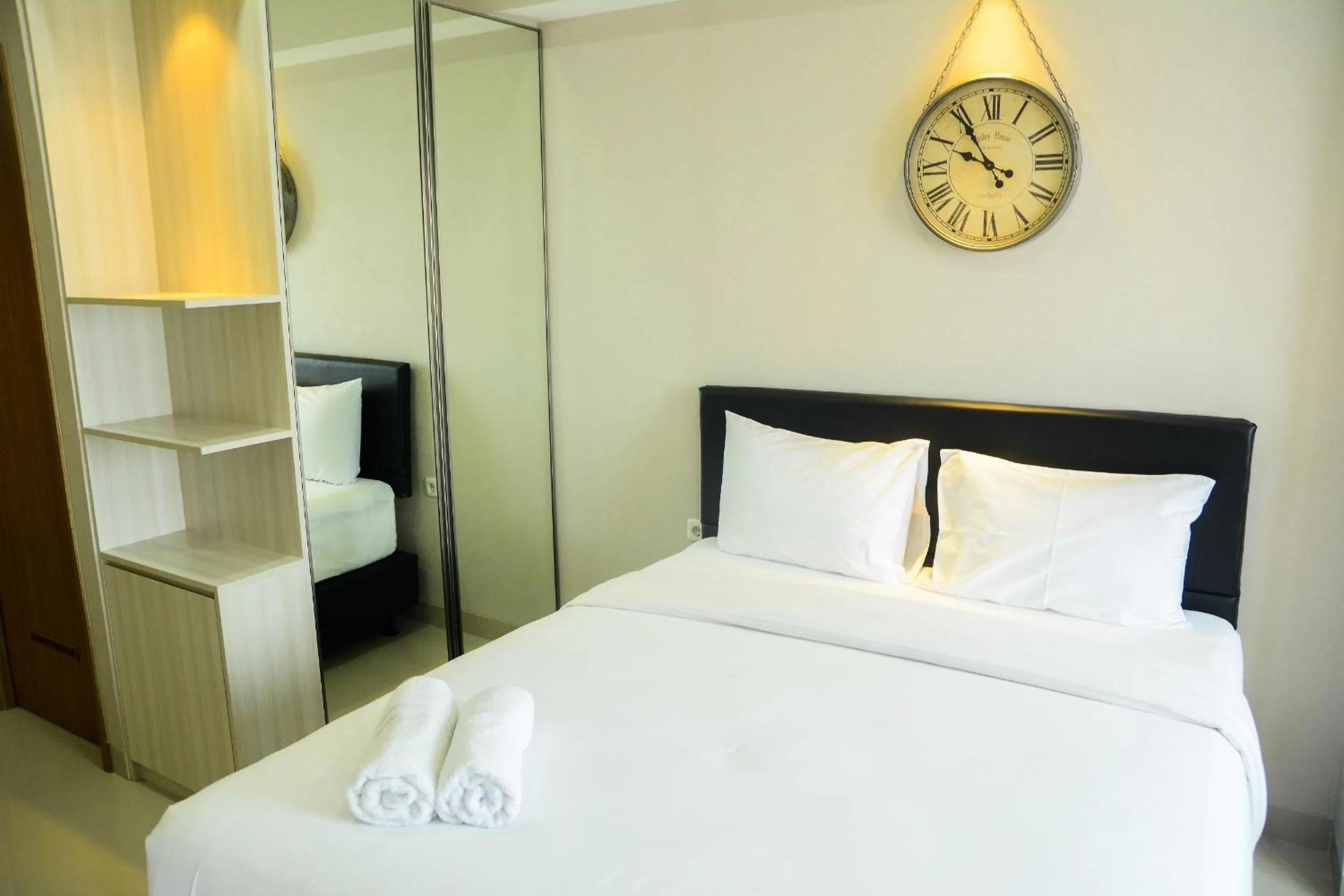 Bed in Sophisticated Studio at The Oasis Apartment By Travelio