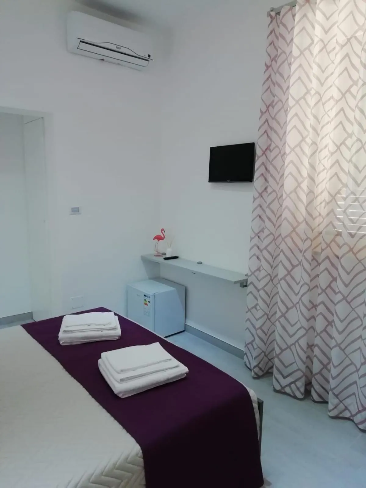 Bed in Flamingo Rooms