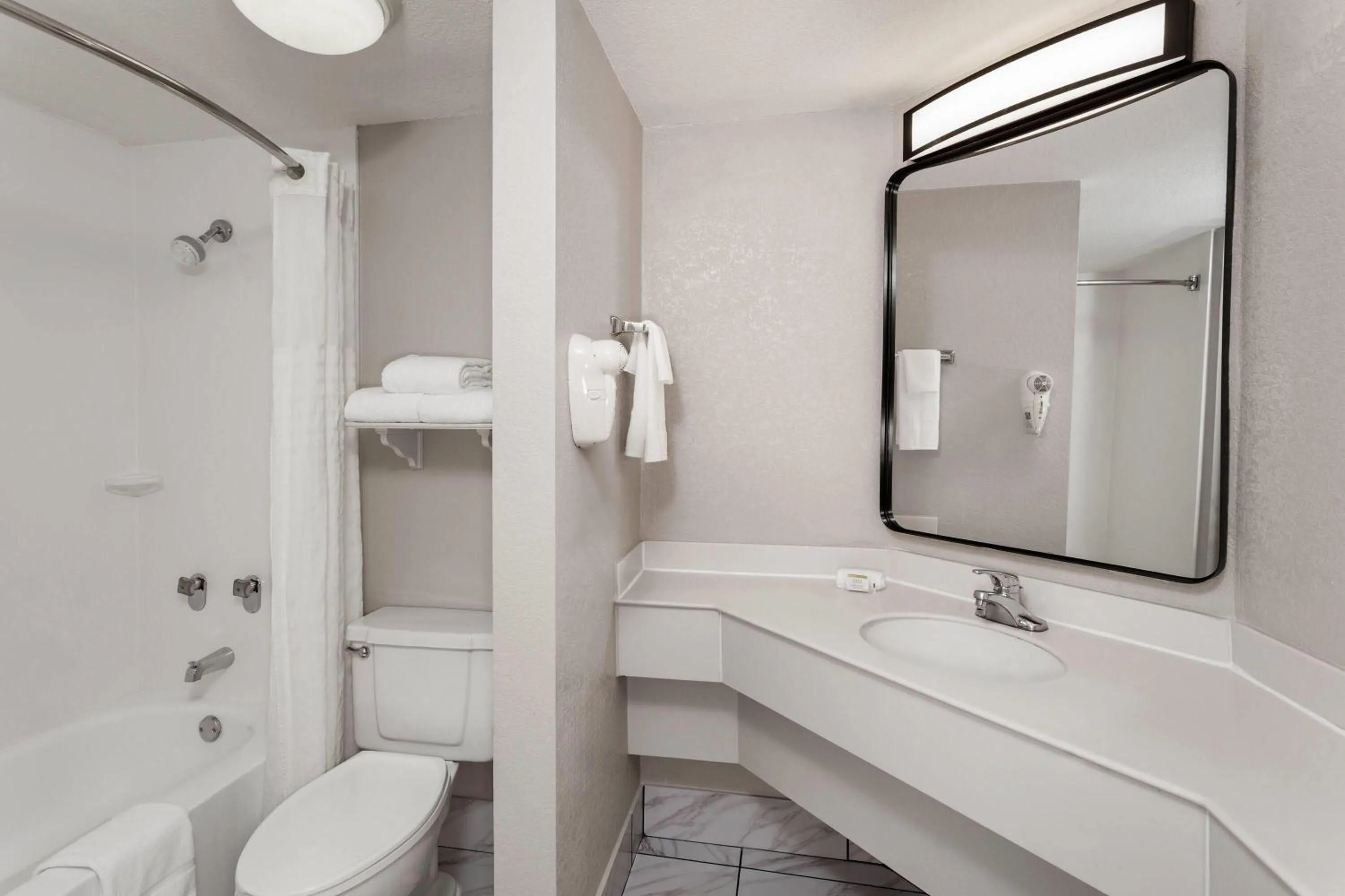 Bathroom in Days Inn & Suites by Wyndham Arlington Heights