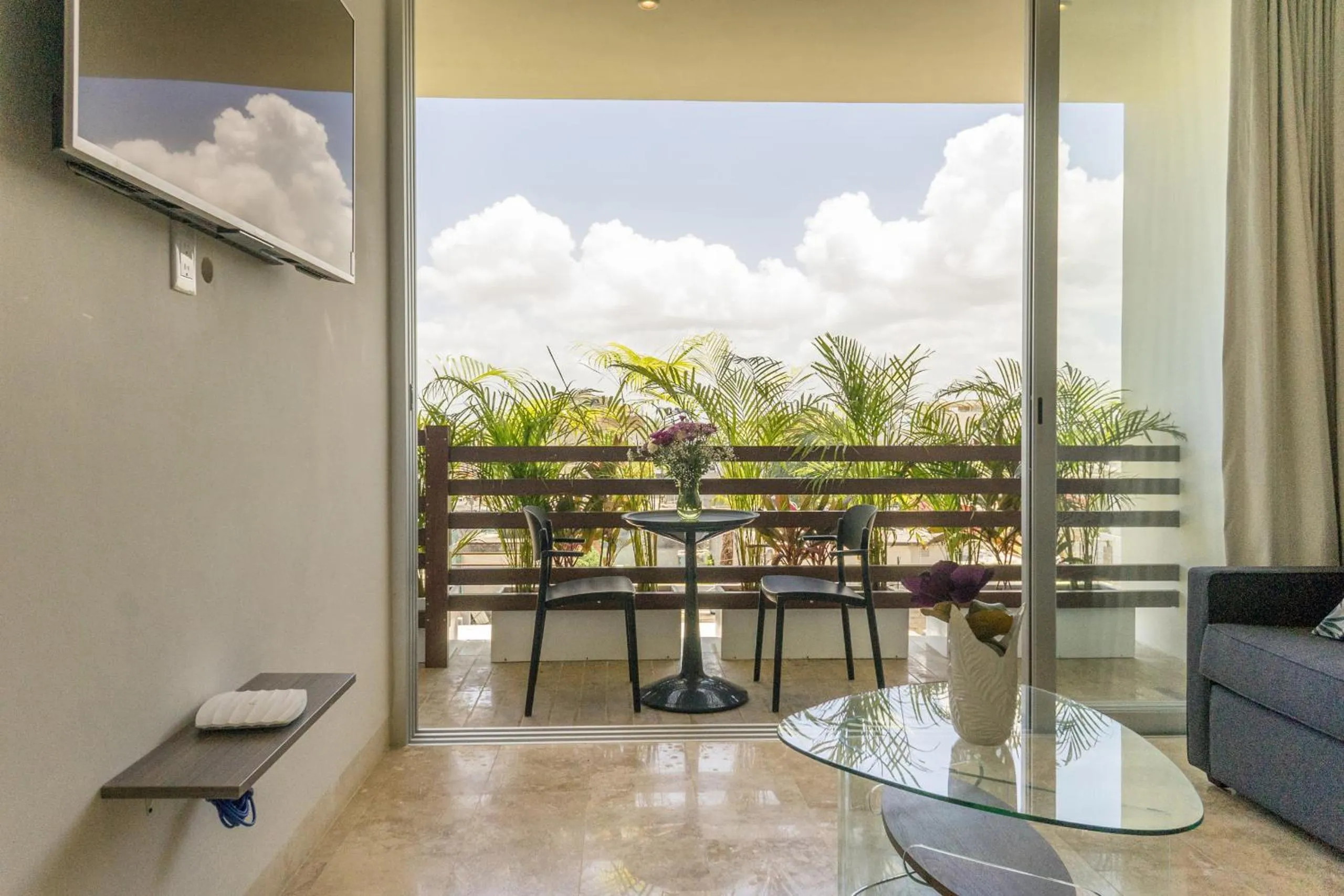 Communal lounge/ TV room in Tropic Playa Apartments