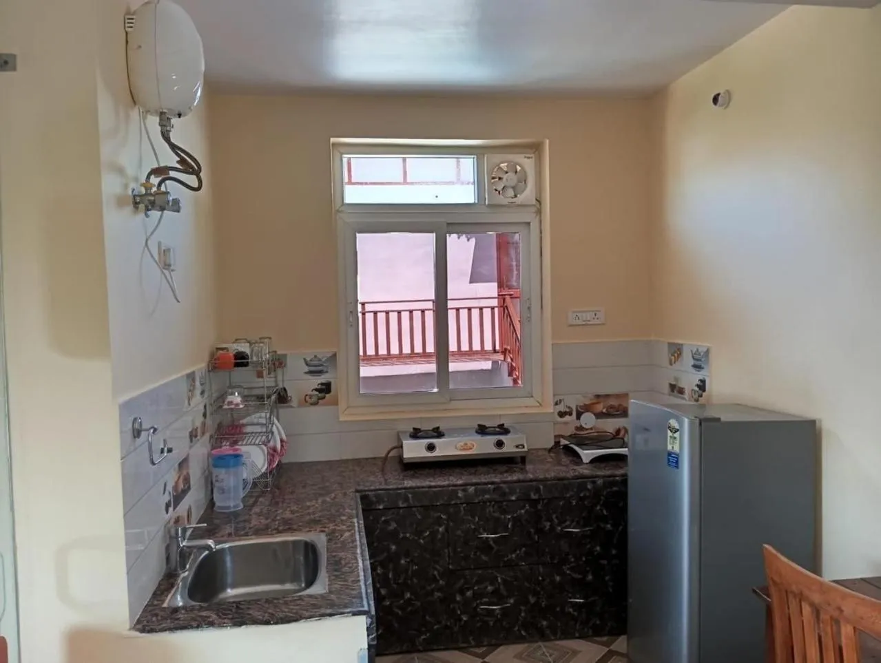 Kitchen or kitchenette in Khushi Cottage