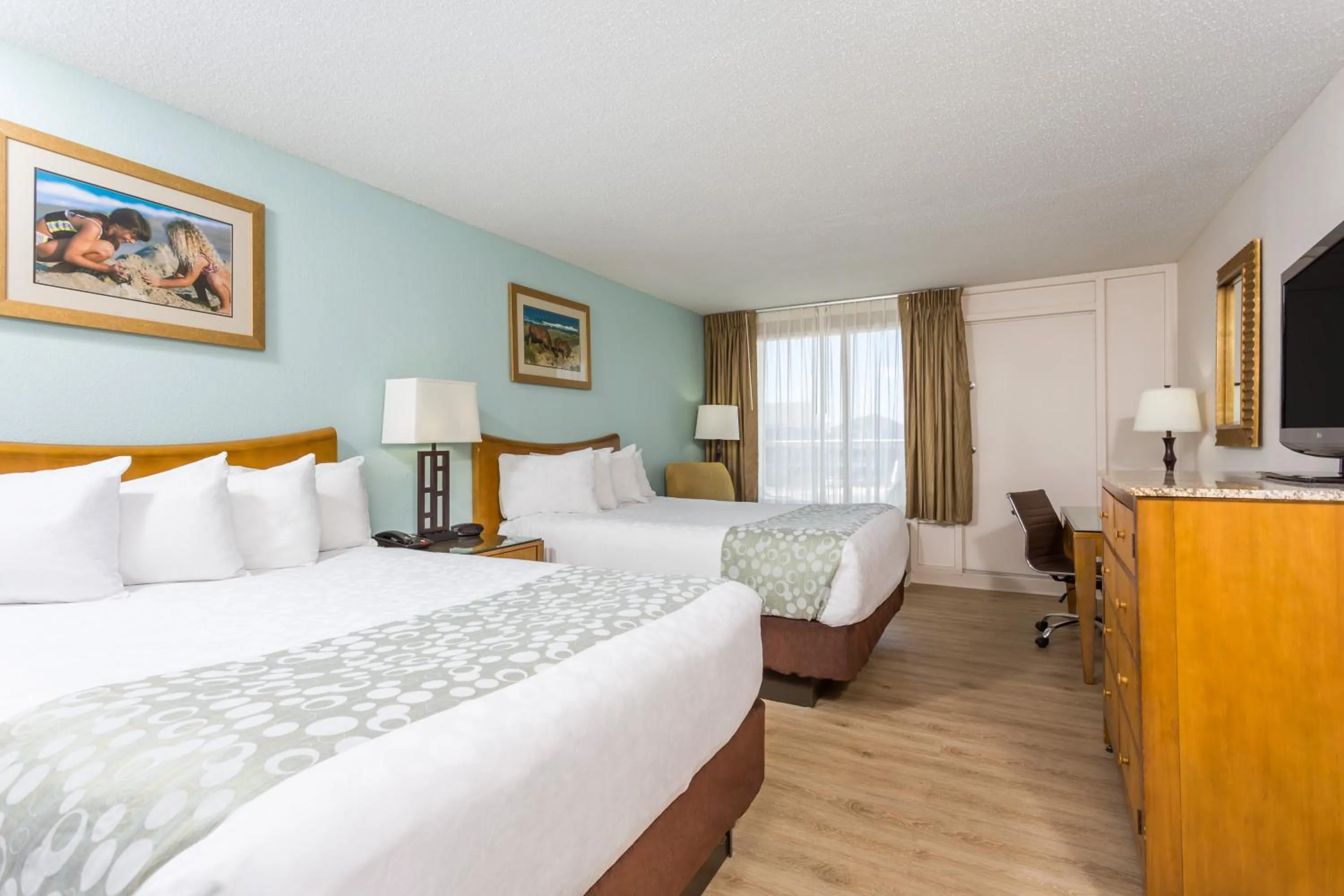 Bed in Ramada Plaza by Wyndham Nags Head Oceanfront