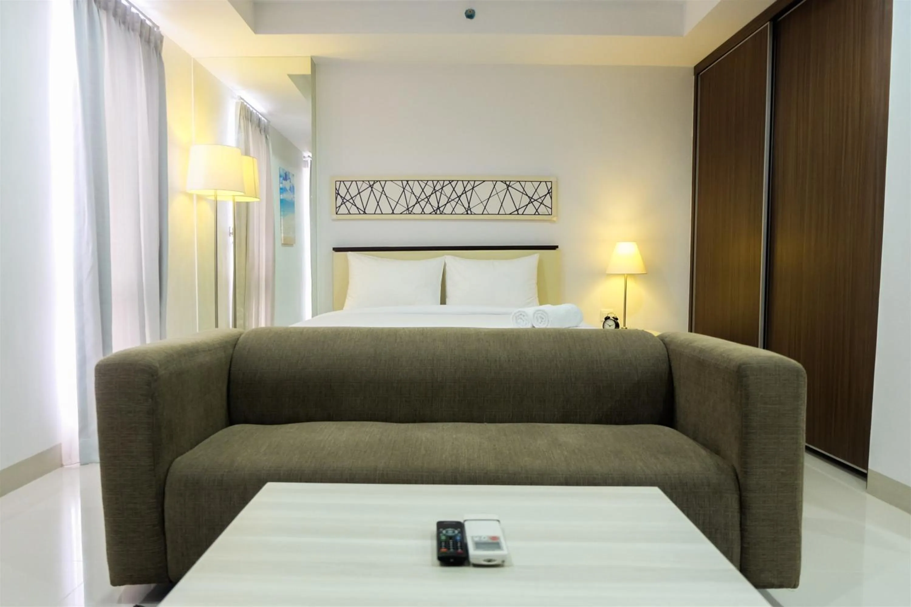 Bed in Studio Room Azalea Suites Apartment By Travelio