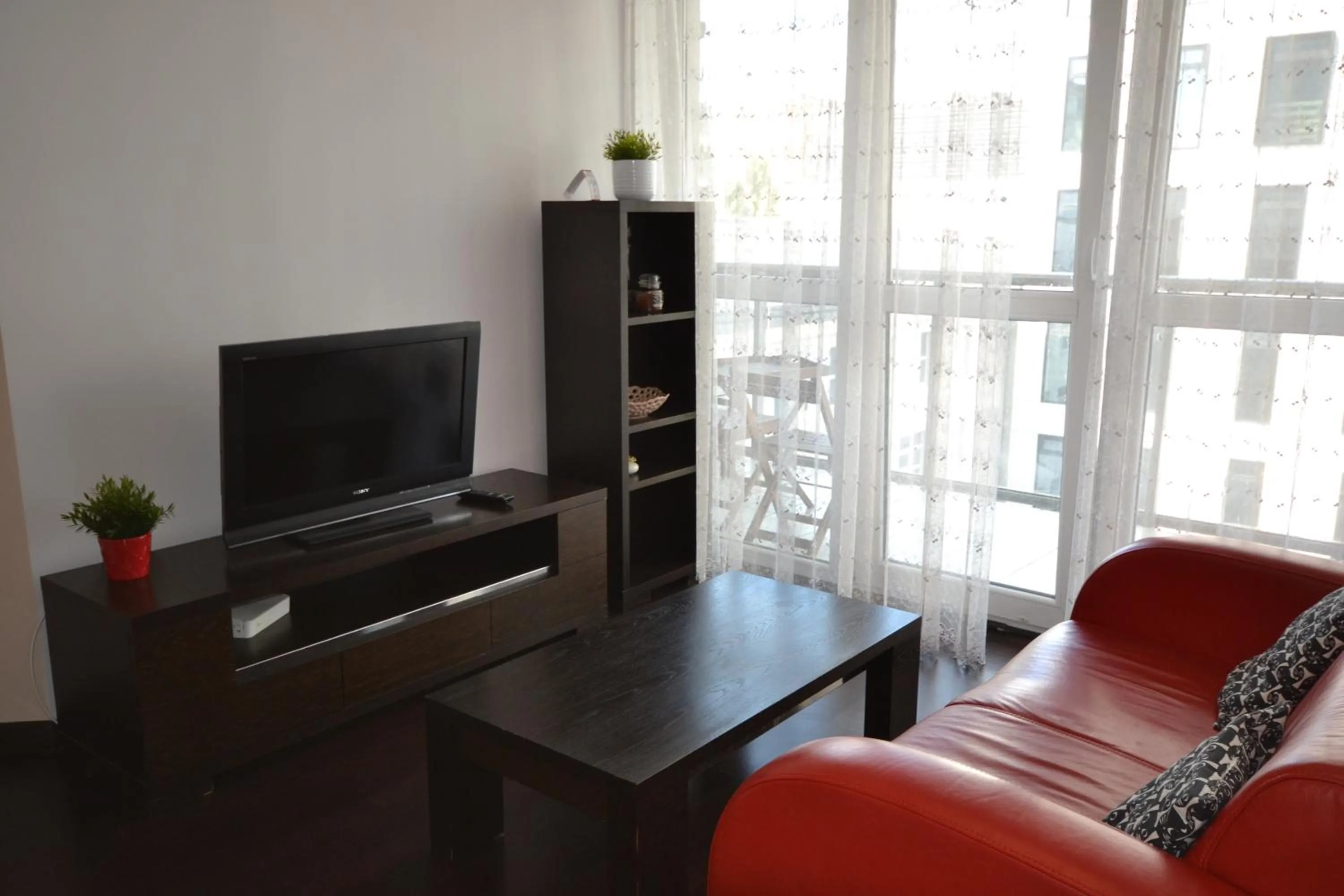 Living room, TV/Entertainment Center in NotaBene Wola Apartment