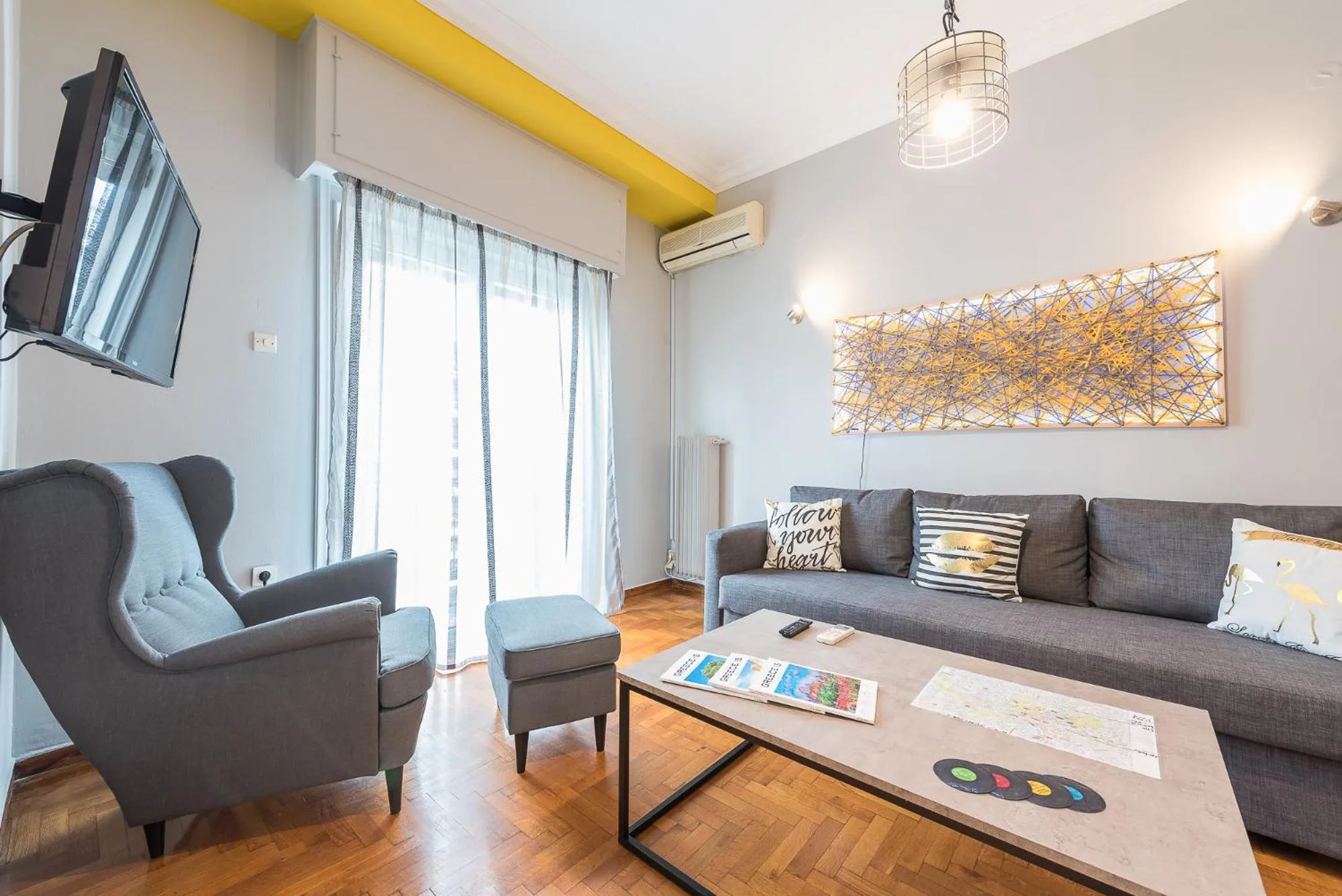 Living room in Athens Boutique Apartment by Cloudkeys