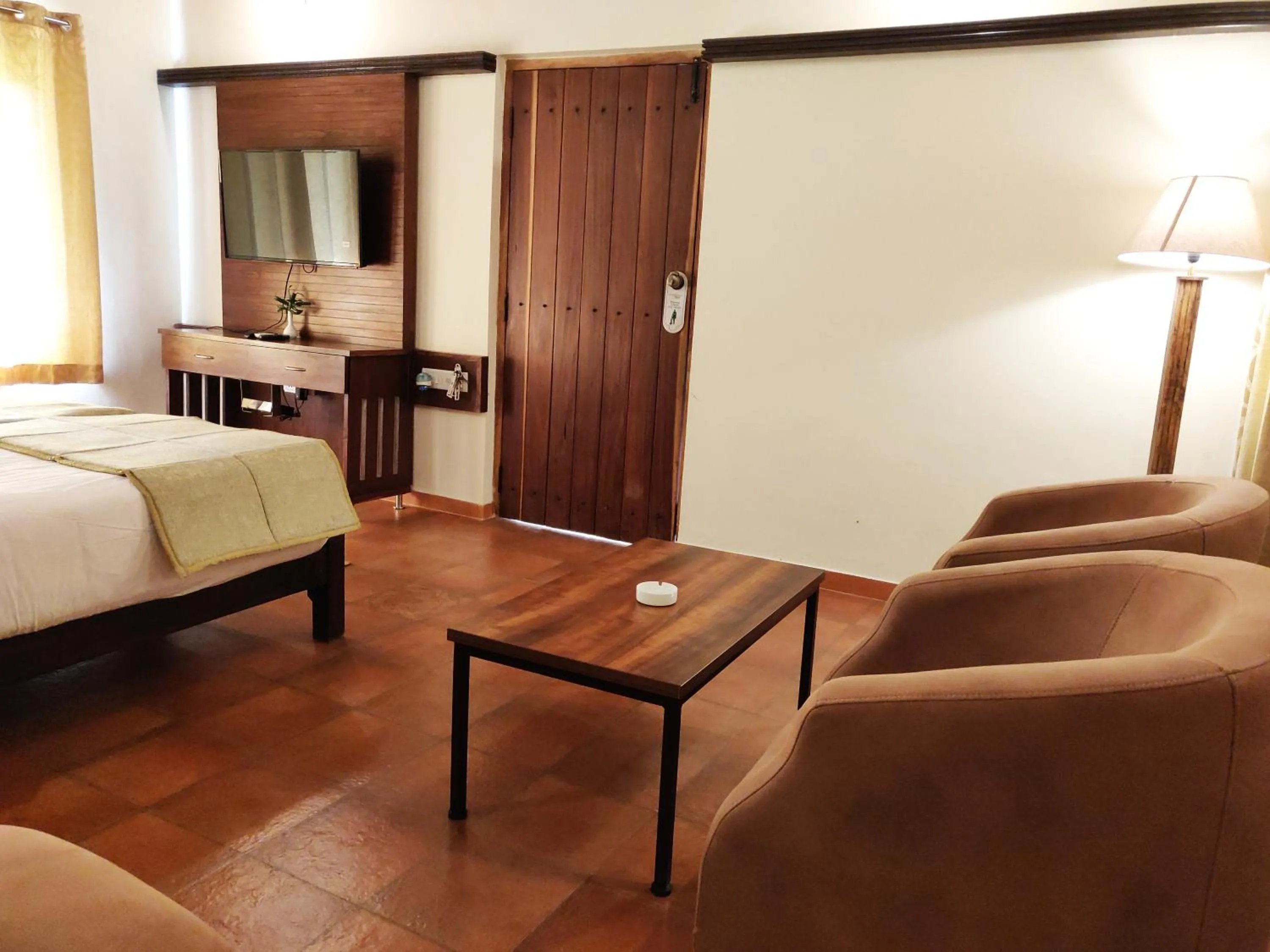 Seating area, Bed in Kadkani River Resort Coorg