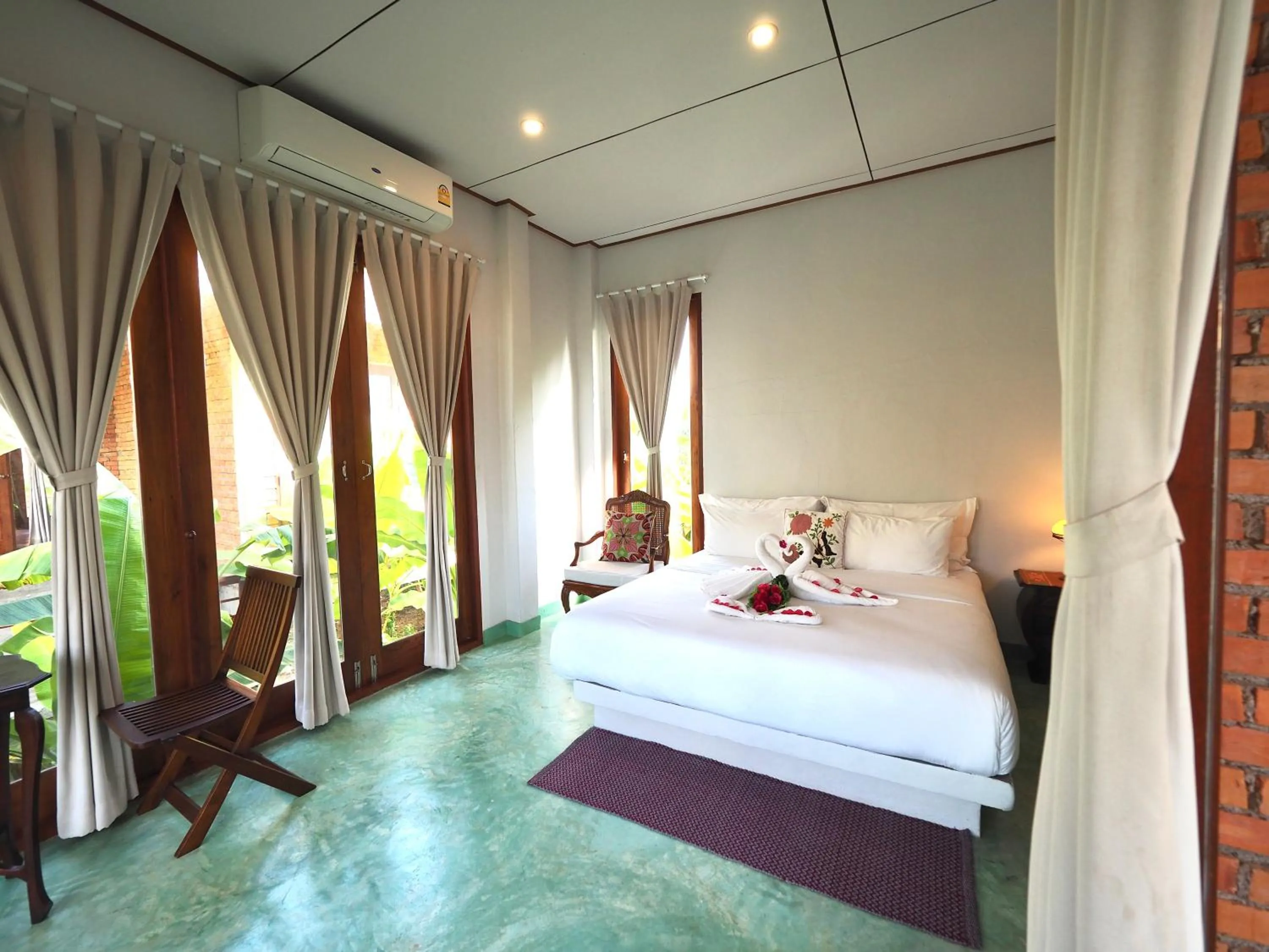 Bed in BaanSuk Sukhothai Resort