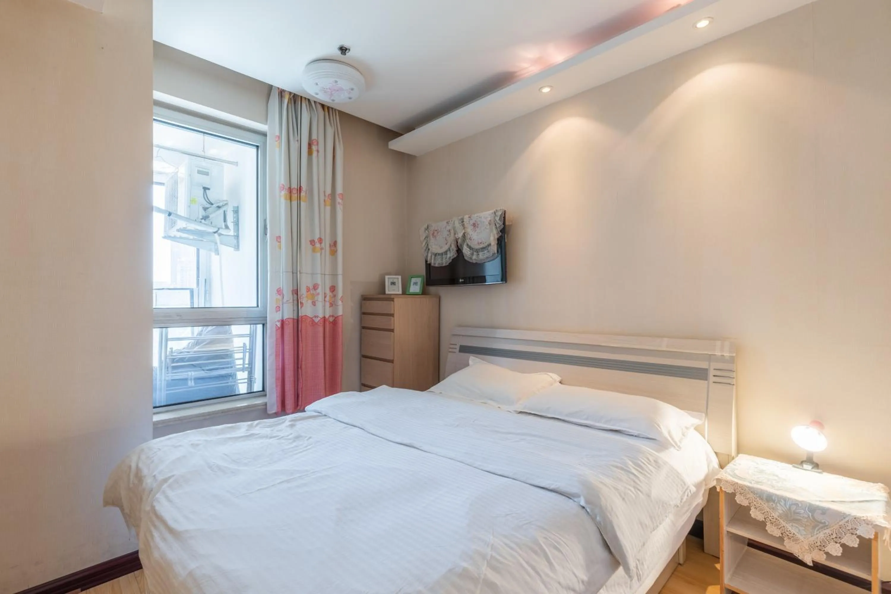 Bed in Dalian Xiuzhu Mansion Apartment