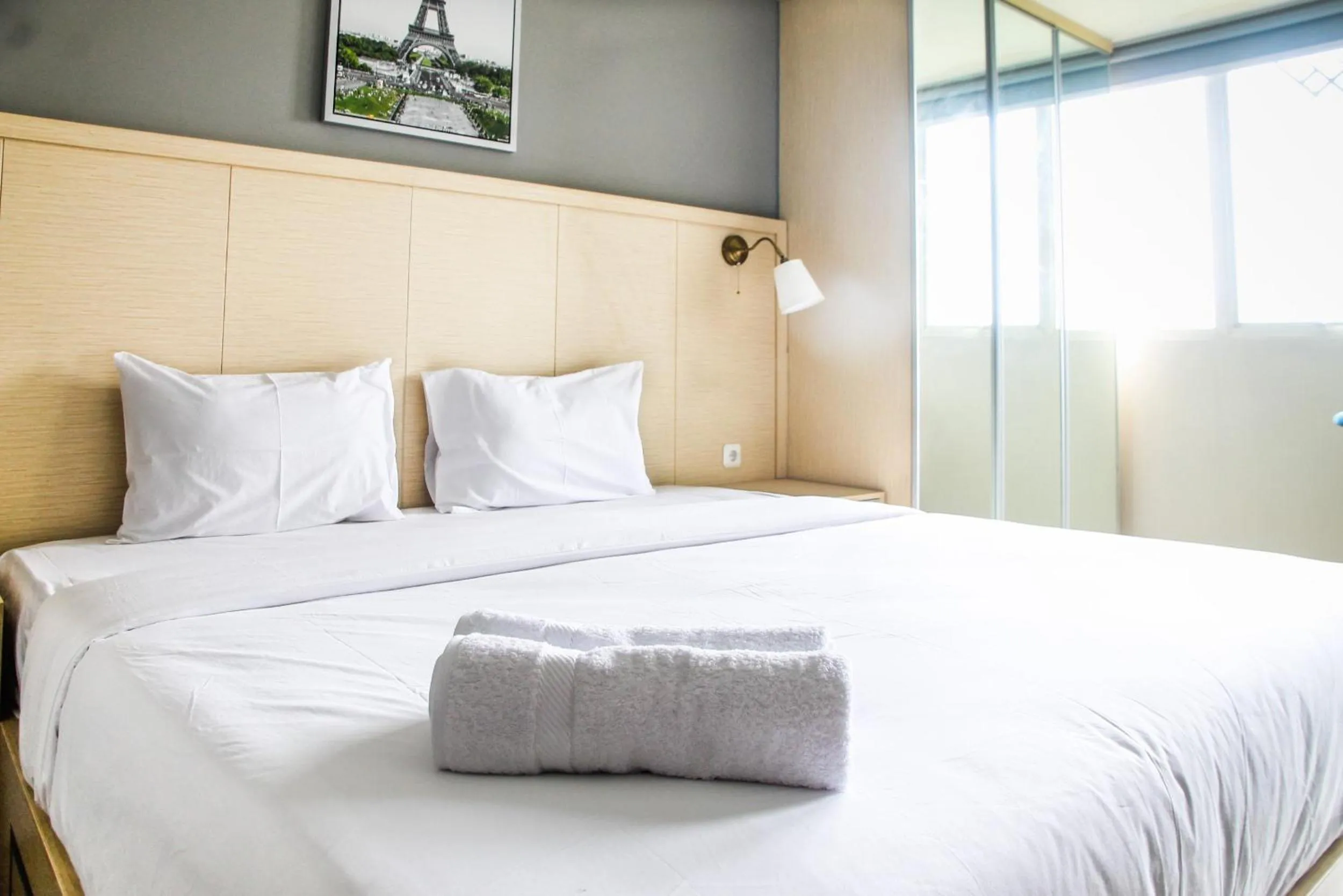 Bed in Modern and Cozy Studio Room The Oasis Cikarang Apartment By Travelio