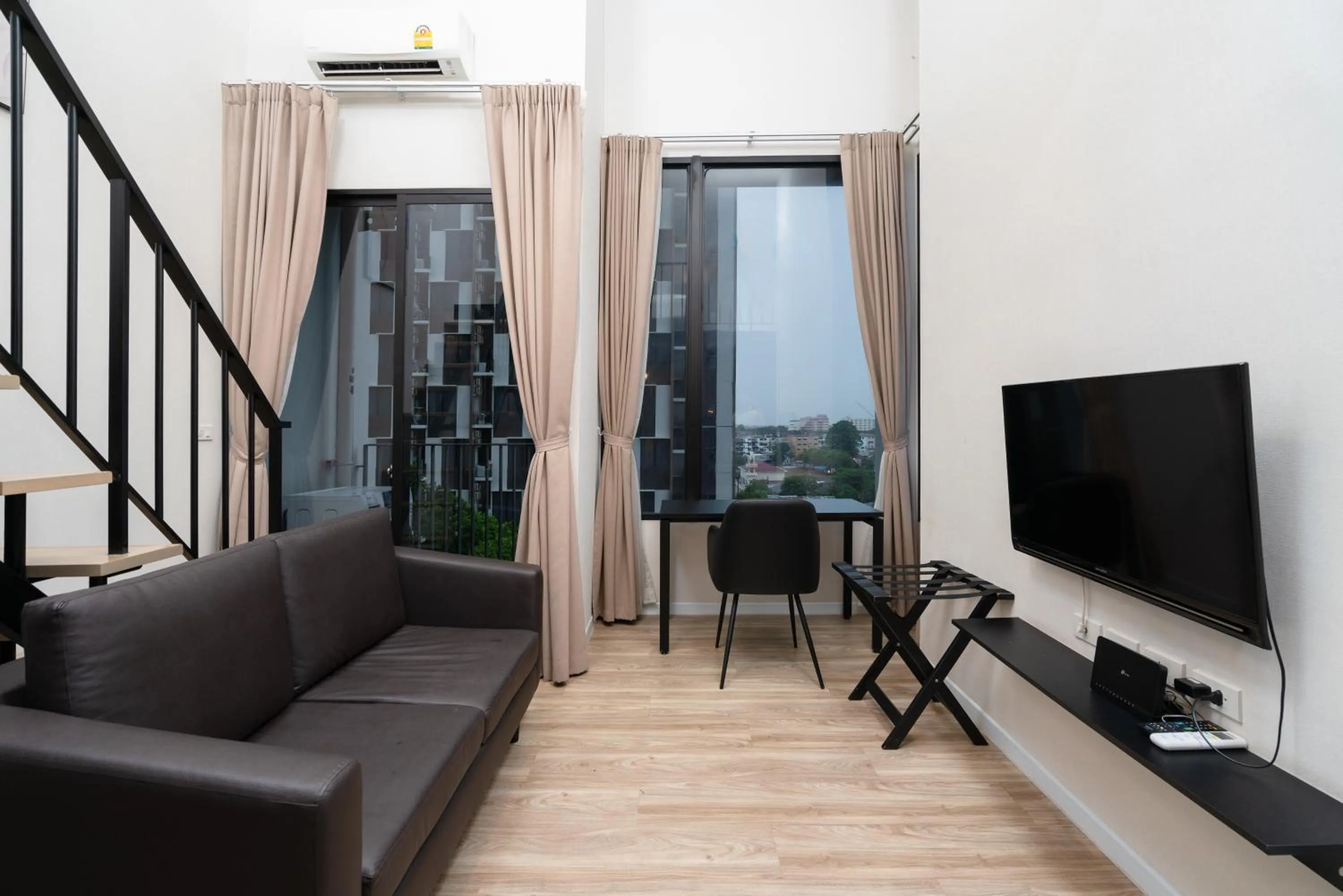 Living room in SureStay by Best Western Bangkok Ramintra