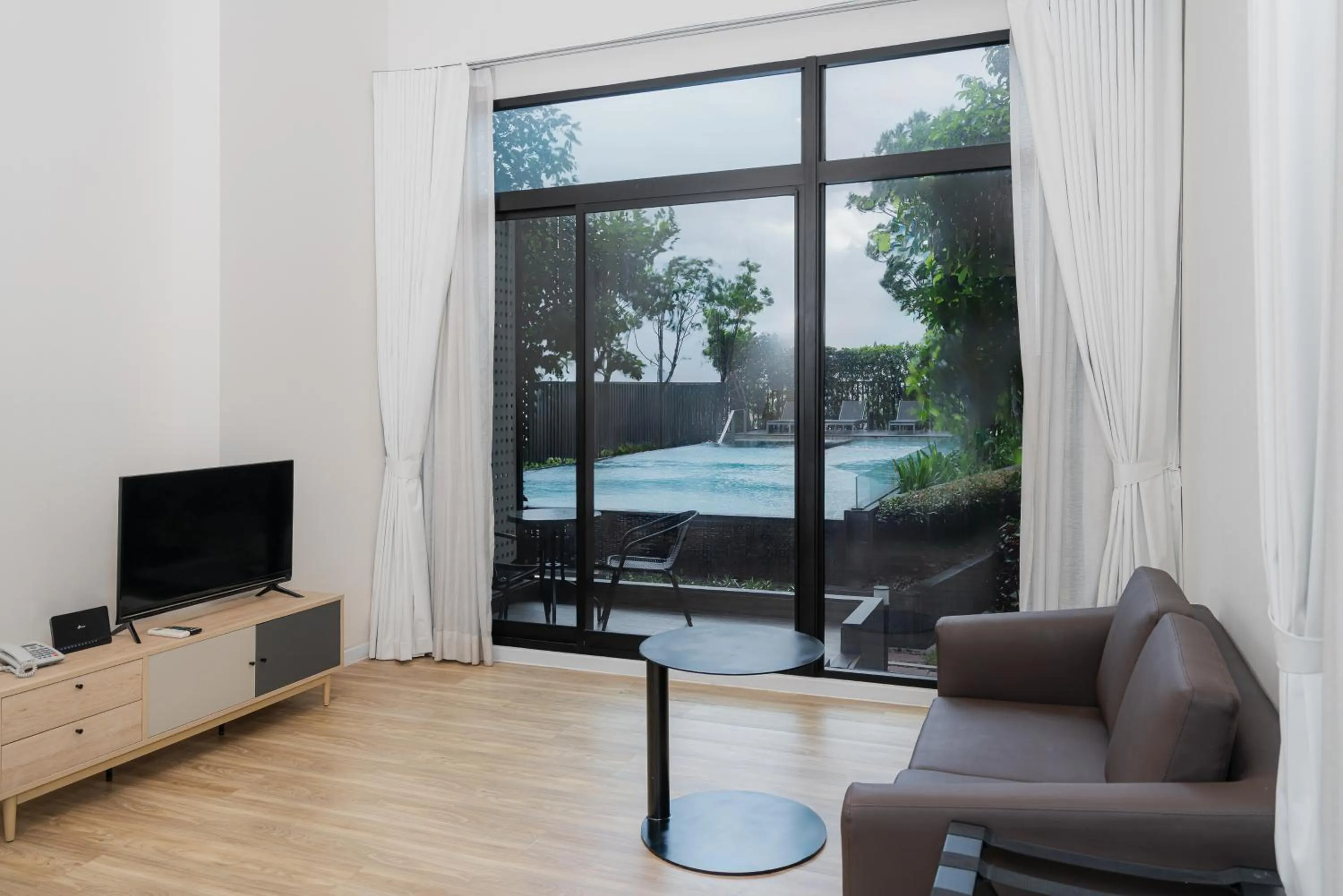 Living room in SureStay by Best Western Bangkok Ramintra