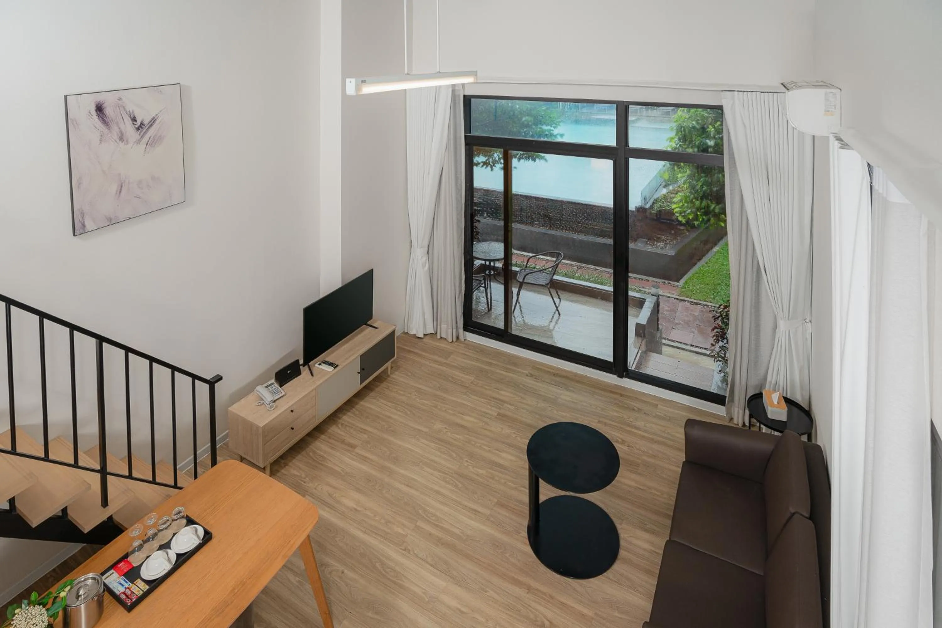 Living room in SureStay by Best Western Bangkok Ramintra