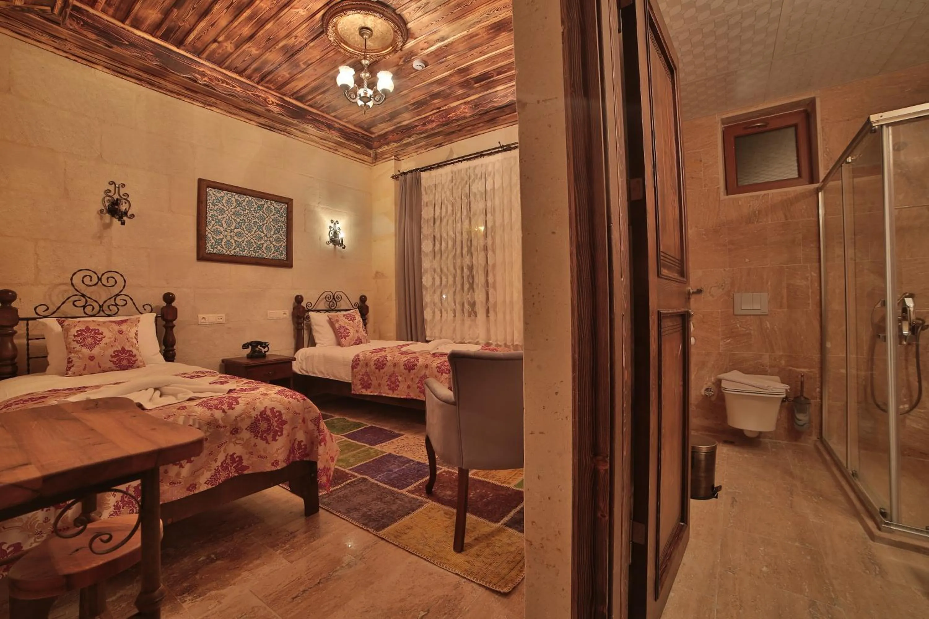 Bed in Caravanserai Inn Hotel