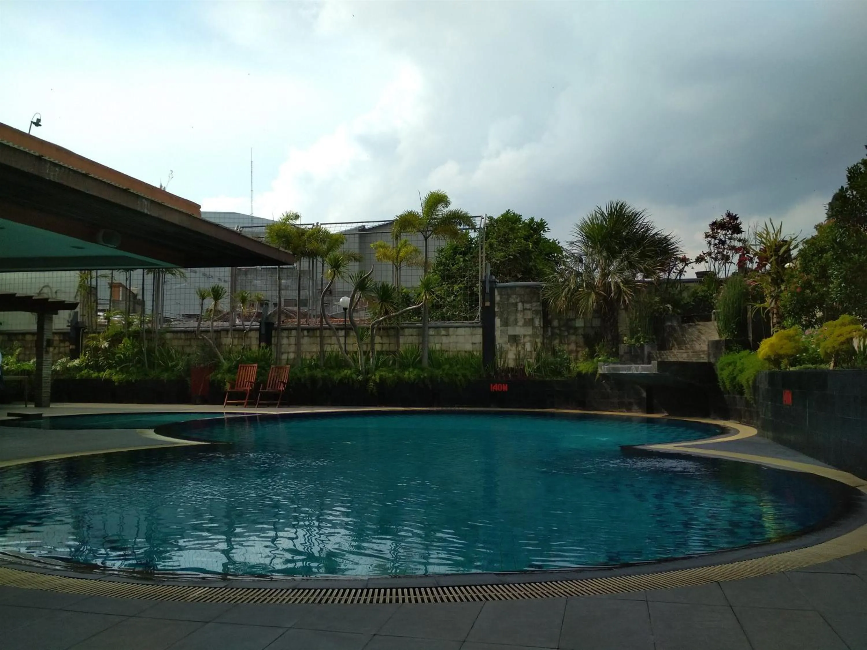 Swimming pool in Antique 3BR at Grand Setiabudi Apartment By Travelio