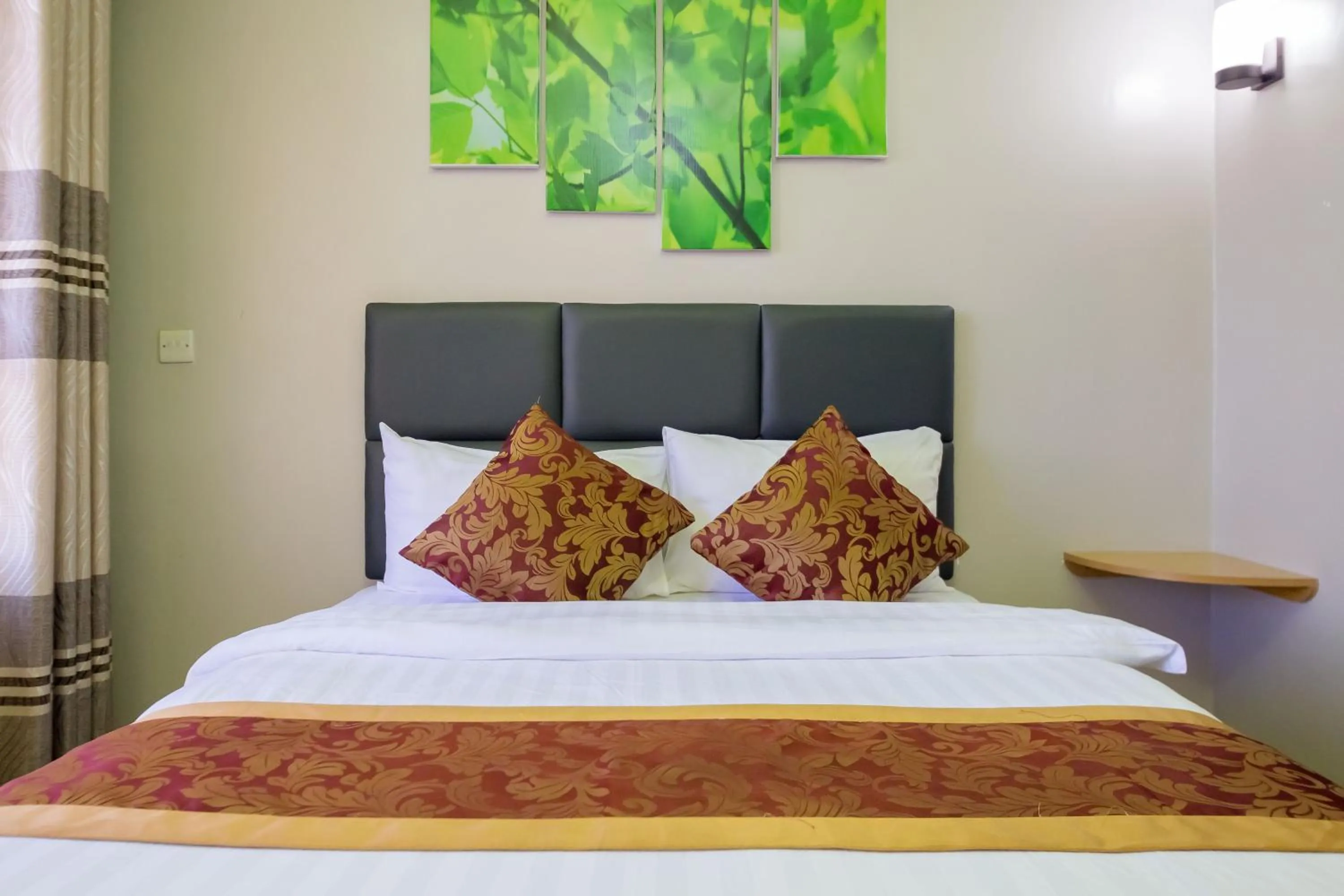 Bed in Maple Inn Hotel