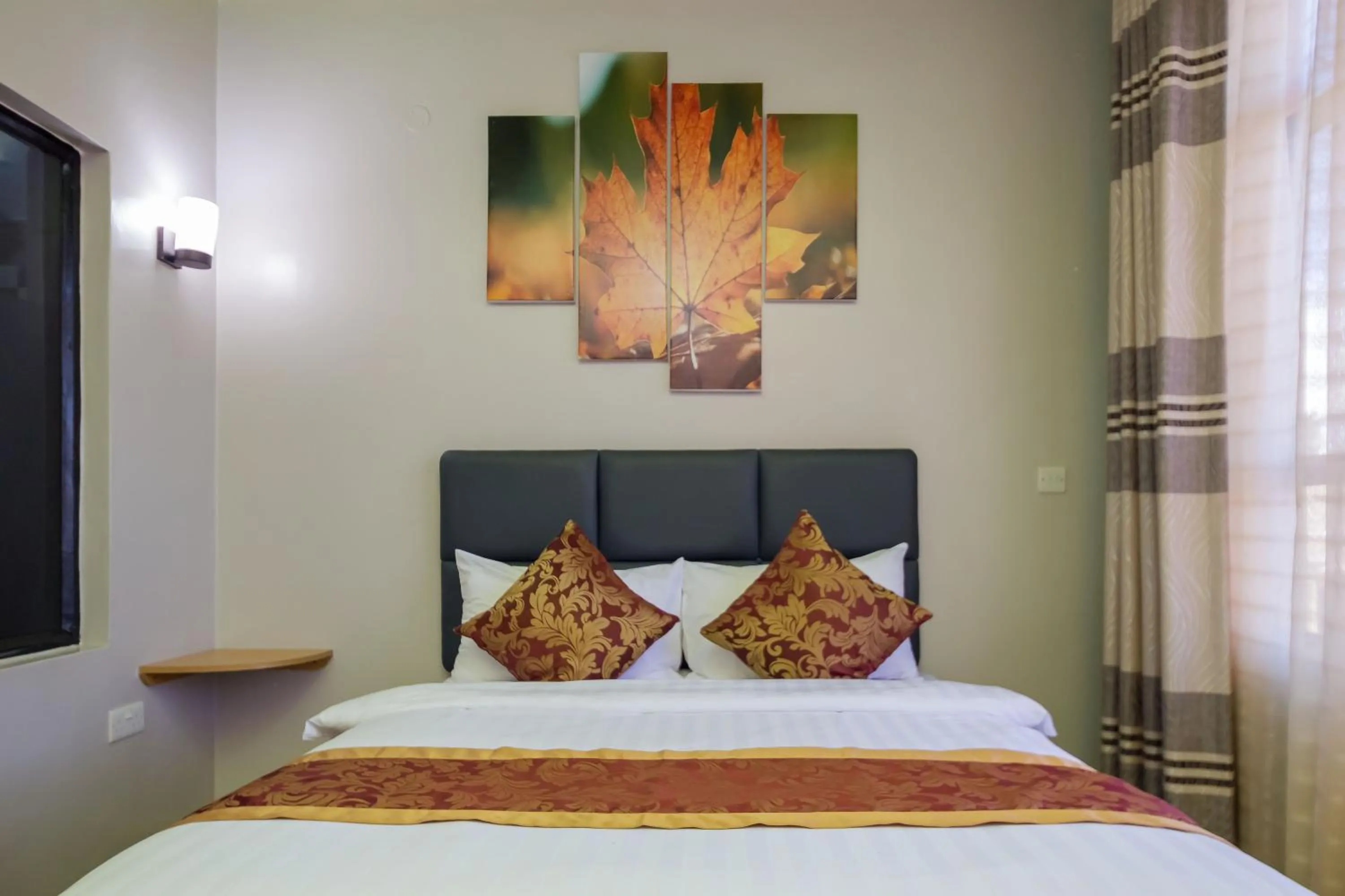 Bed in Maple Inn Hotel