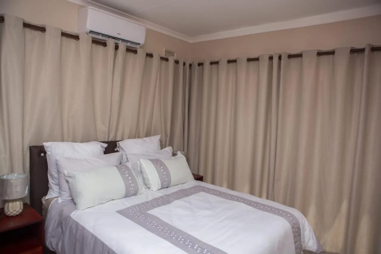 Bed in DYNA GUEST HOUSE