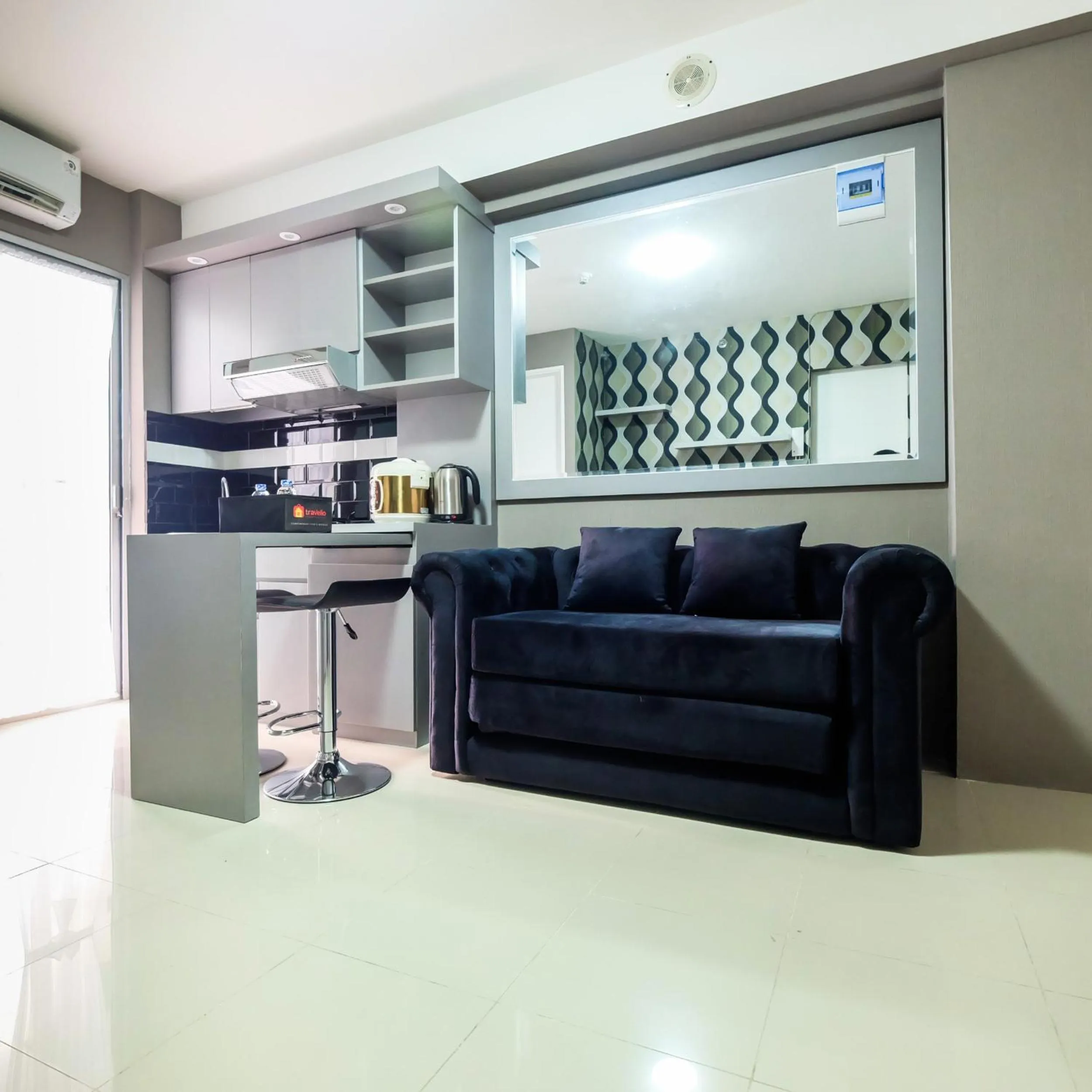 Living room in Modern and Comfort 2BR Bassura City Apartment By Travelio