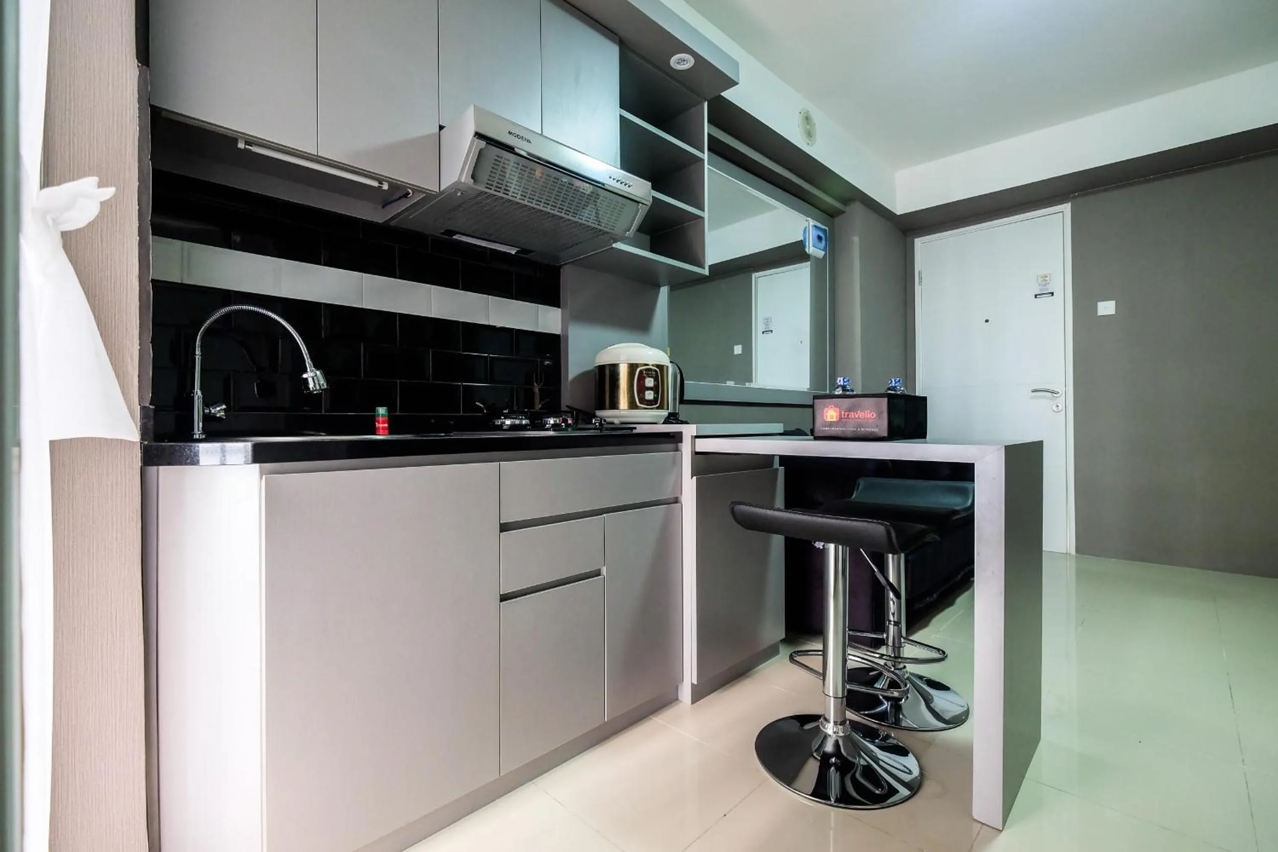 Kitchen or kitchenette in Modern and Comfort 2BR Bassura City Apartment By Travelio