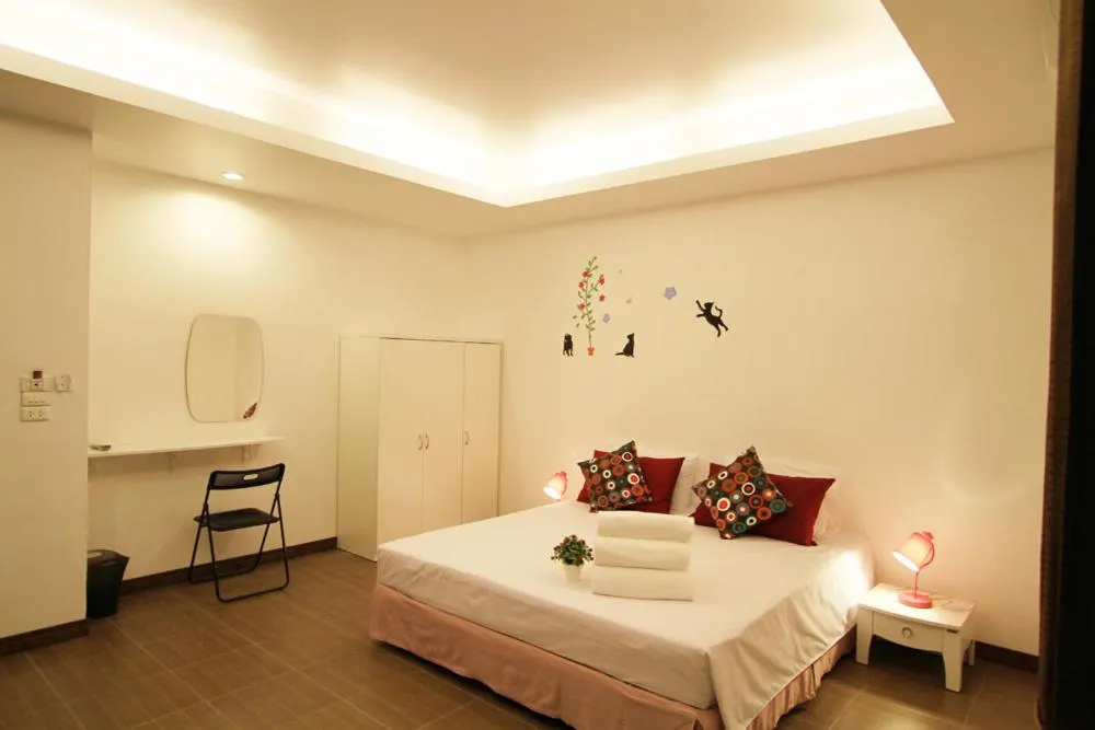 Bed in White Cat Hotel