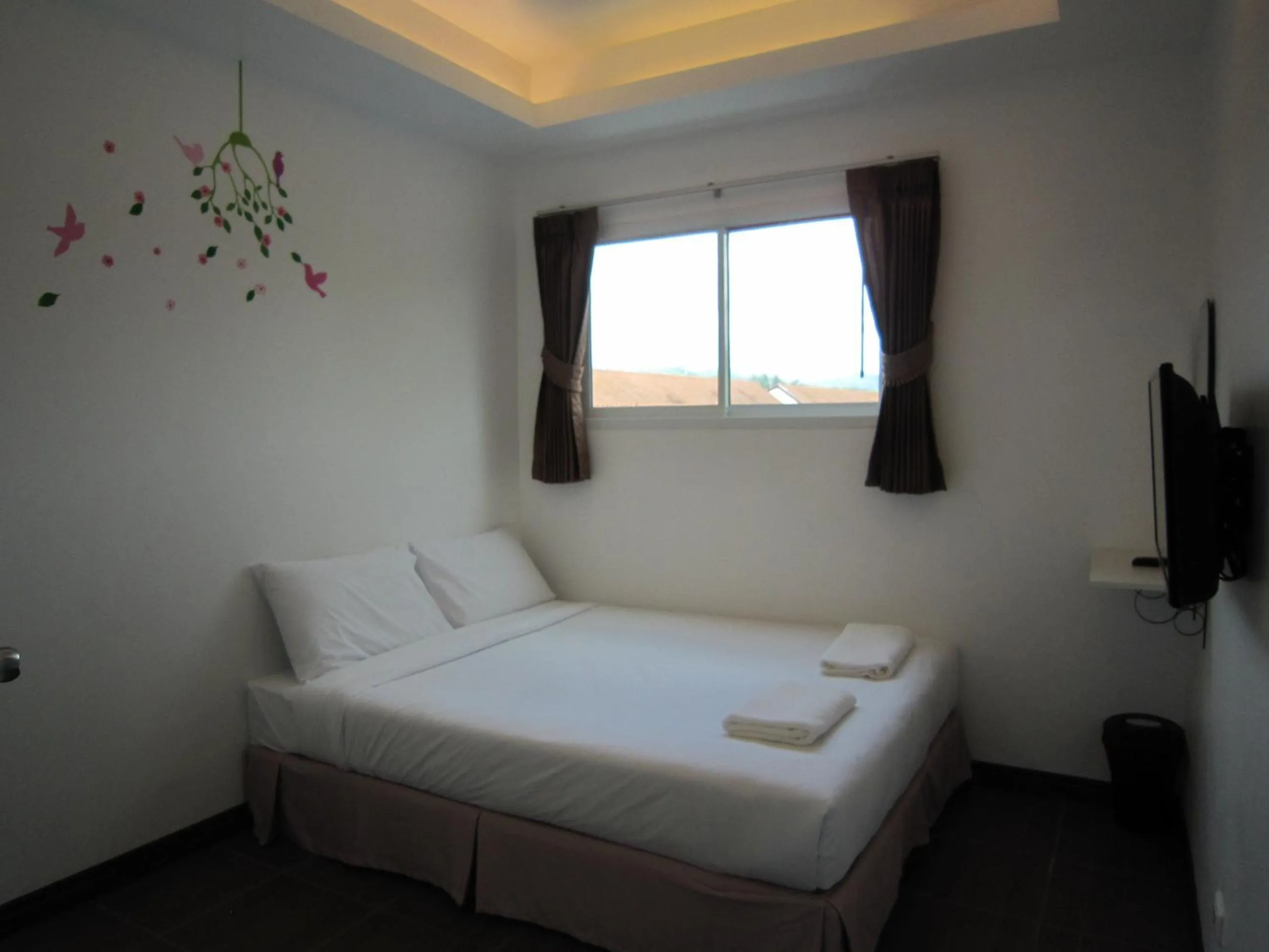 Bed in White Cat Hotel