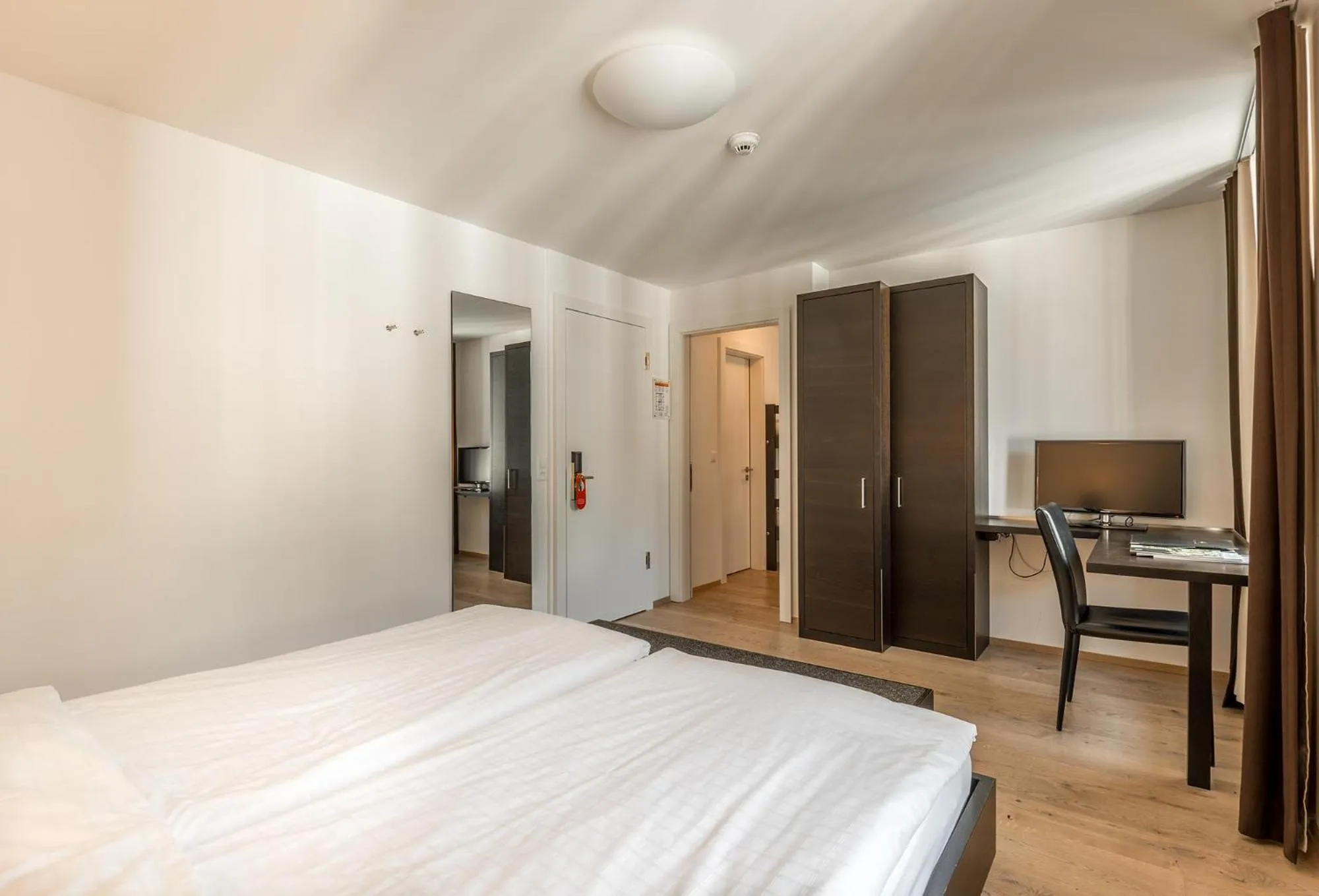 Photo of the whole room, Bed in Hotel Alpina Luzern