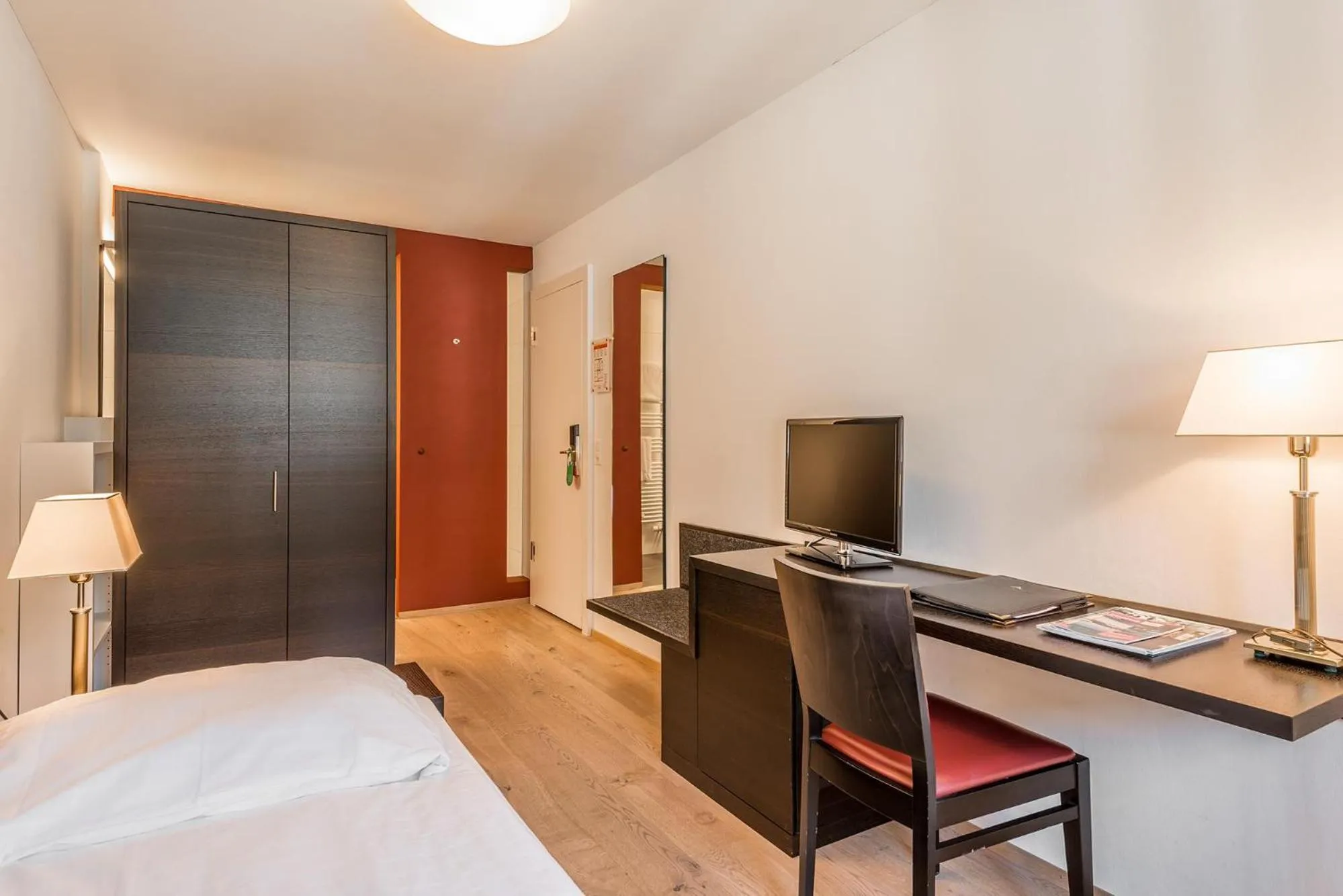 Photo of the whole room, Bed in Hotel Alpina Luzern