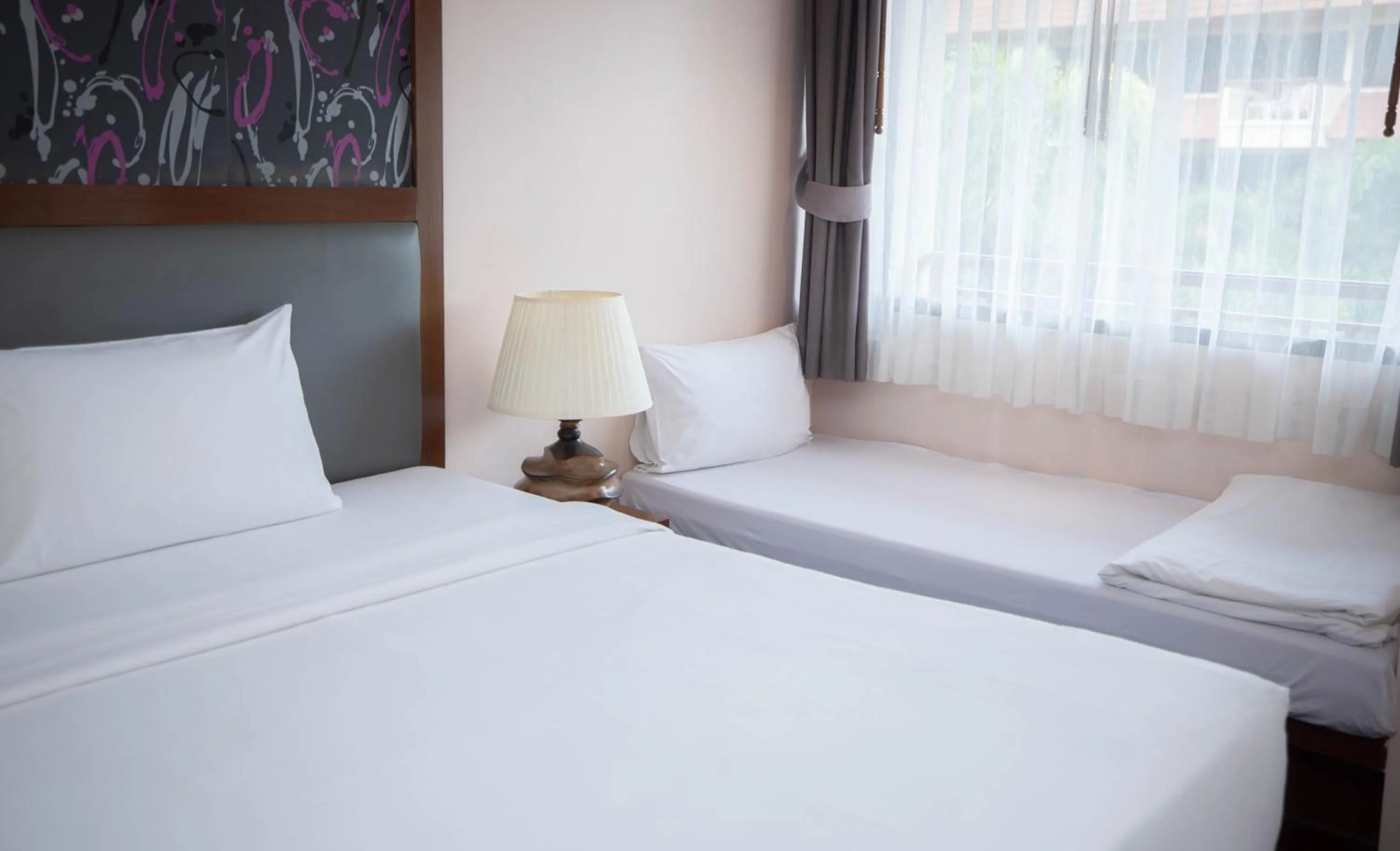 Bed in Baumanburi Hotel Patong