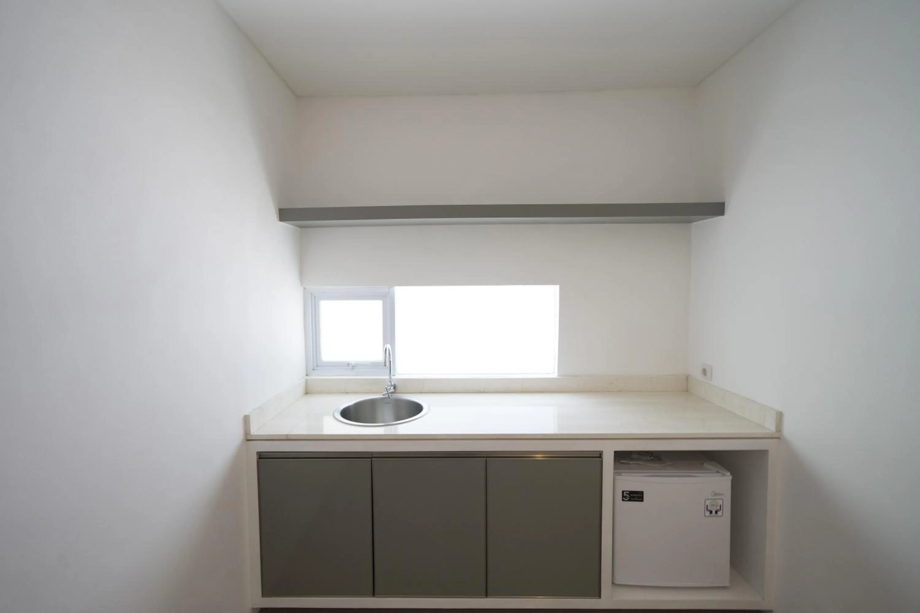 Kitchen or kitchenette in The Rooms Apartment Bali by ARM Hospitality