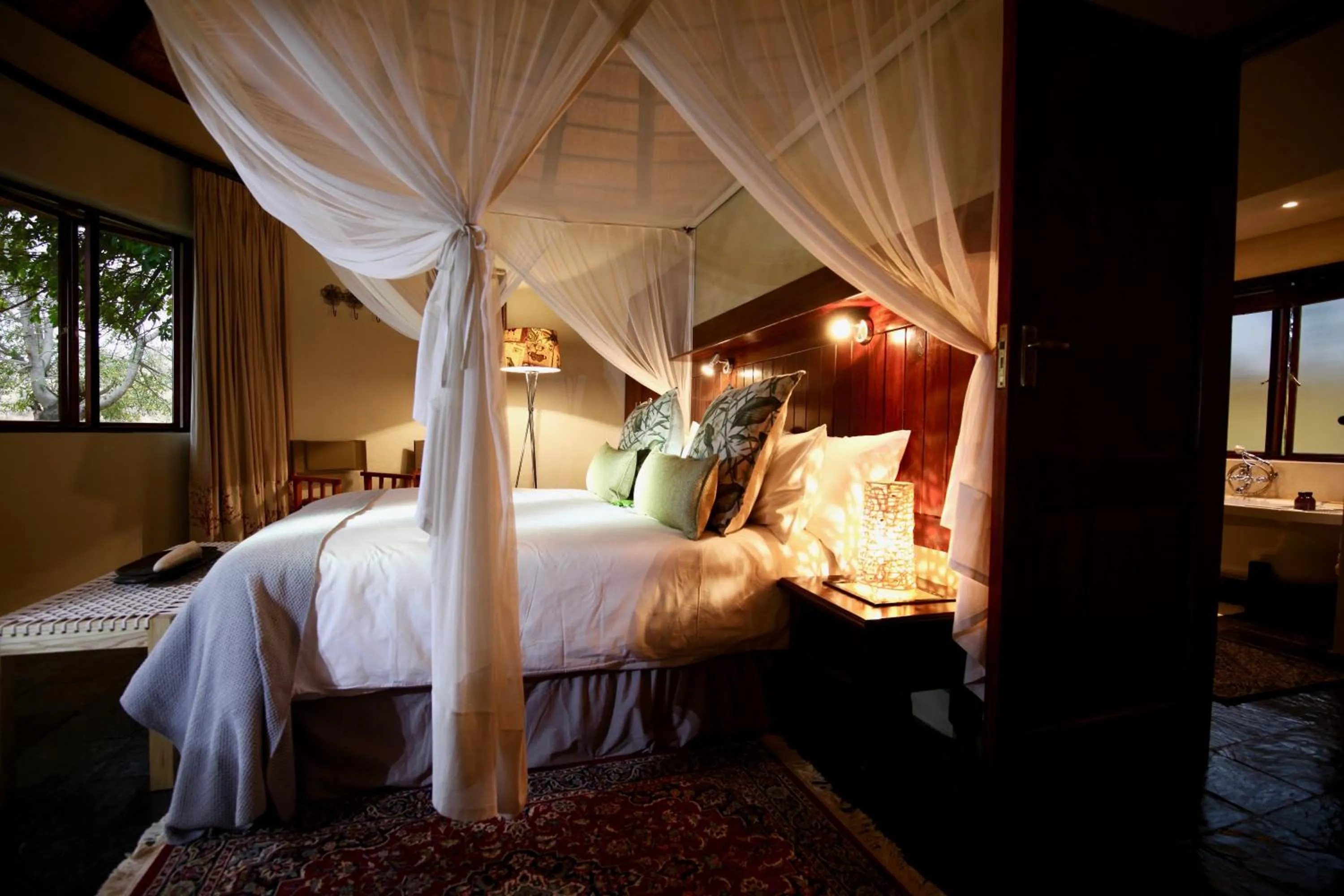 Bed in Ivory Wilderness River Rock Lodge
