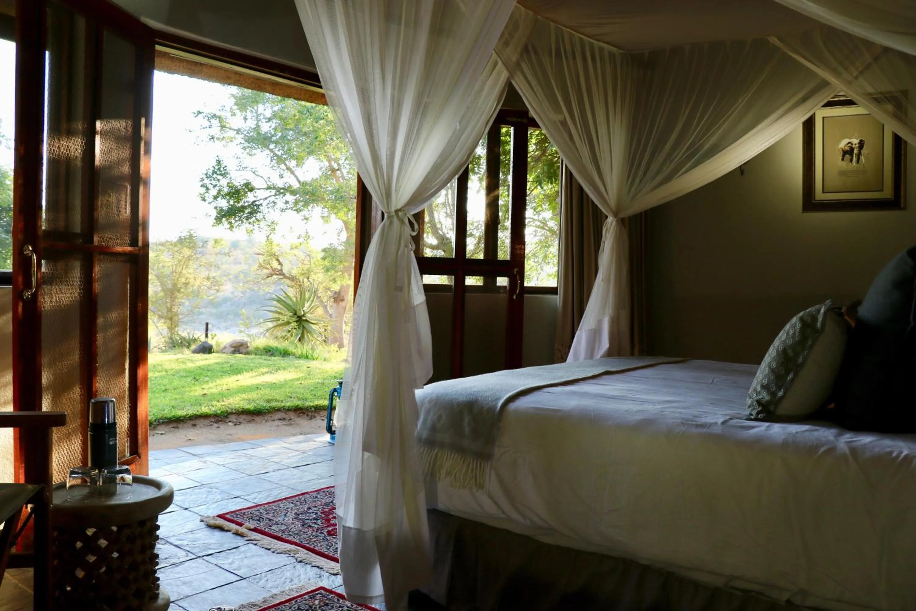 Bed in Ivory Wilderness River Rock Lodge