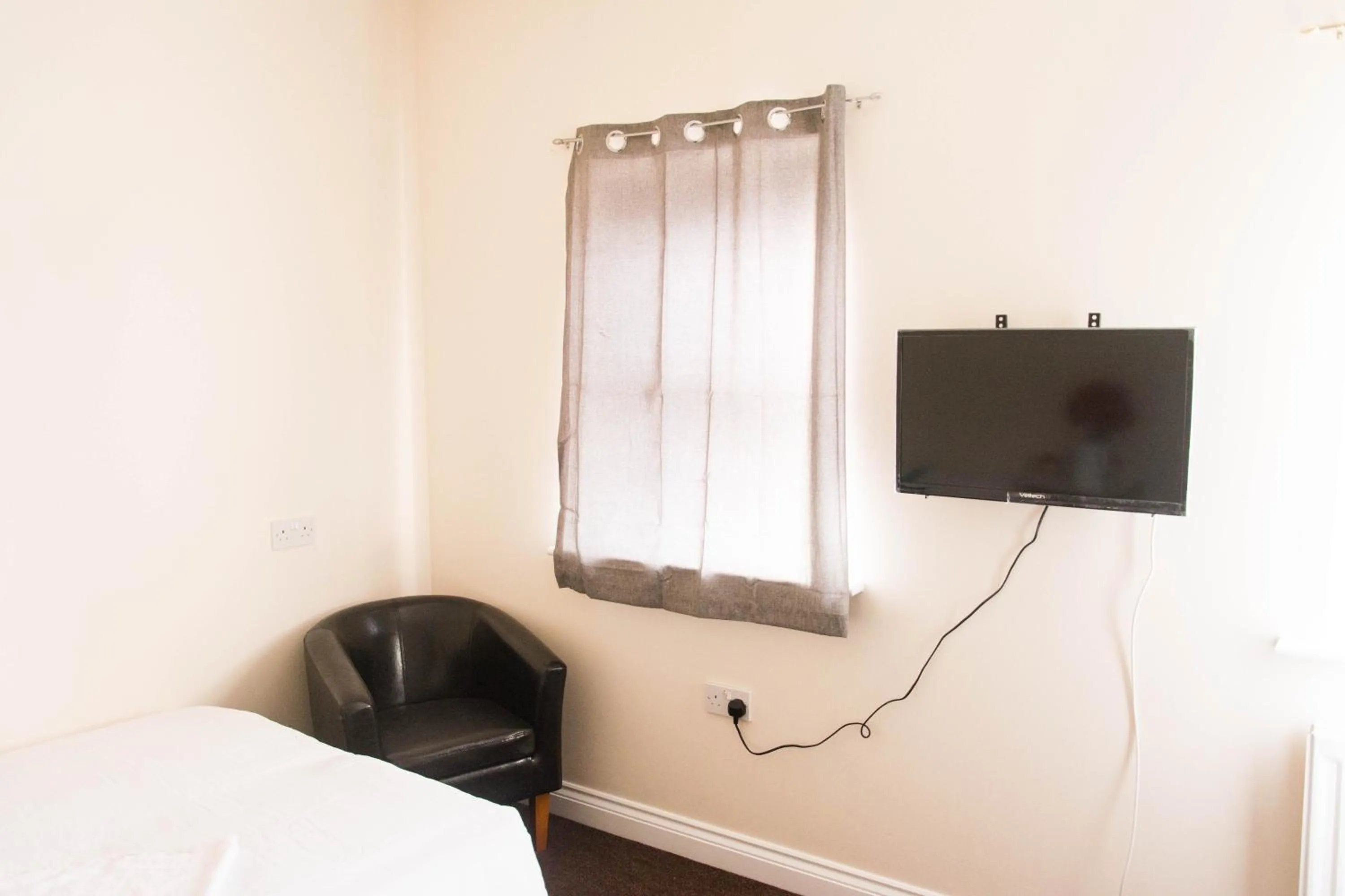 Bed in QUEEN GUEST HOUSE