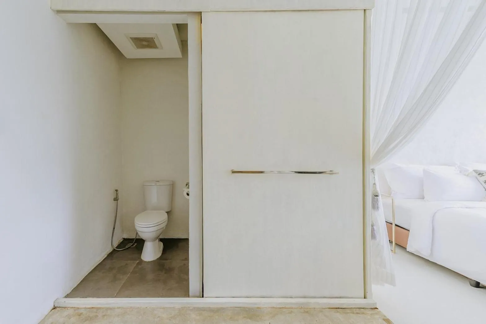 Toilet, Bed in White Wall Riverfront Hotel