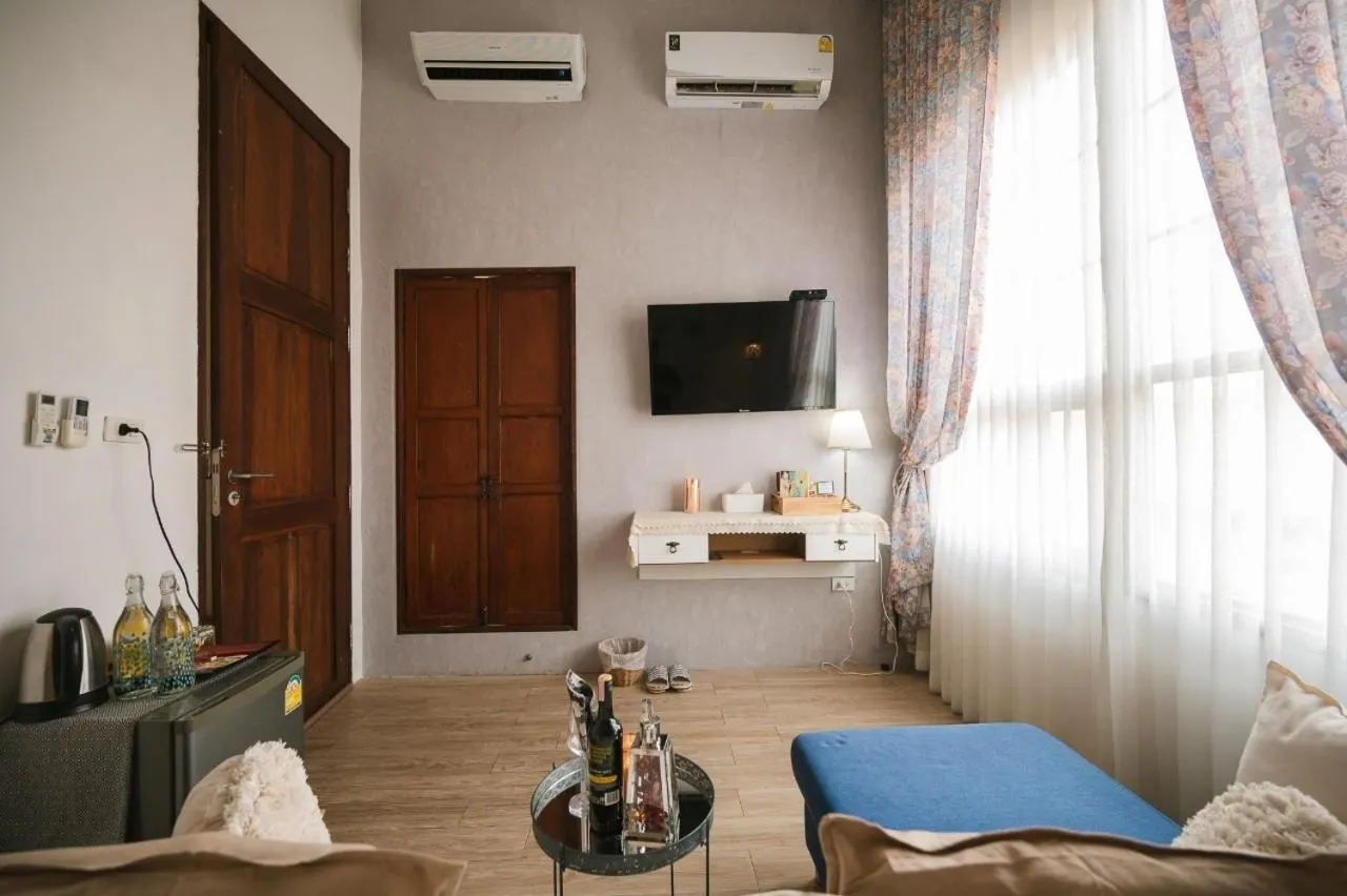 Bed in White Wall Riverfront Hotel