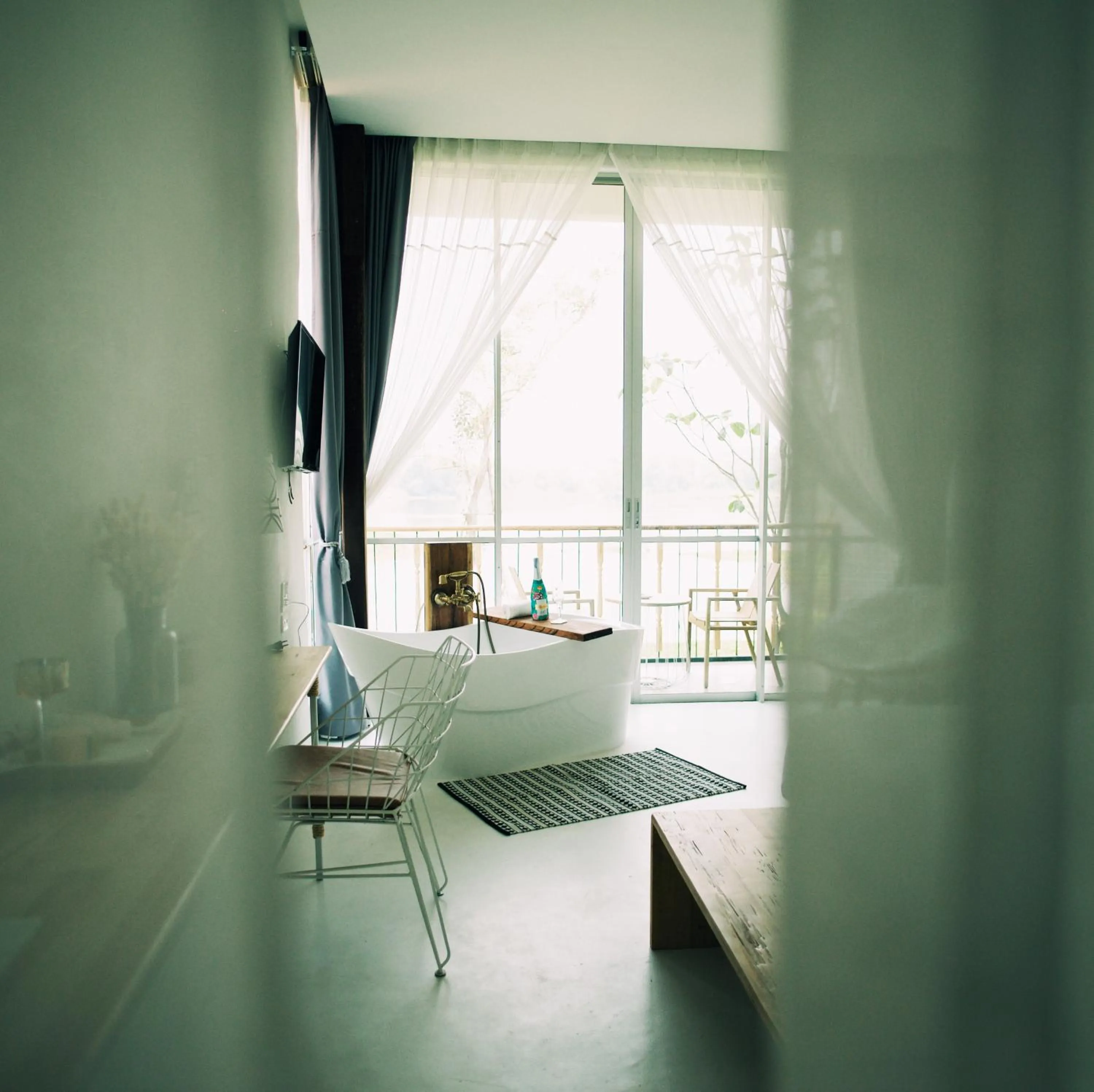 Photo of the whole room, Bed in White Wall Riverfront Hotel