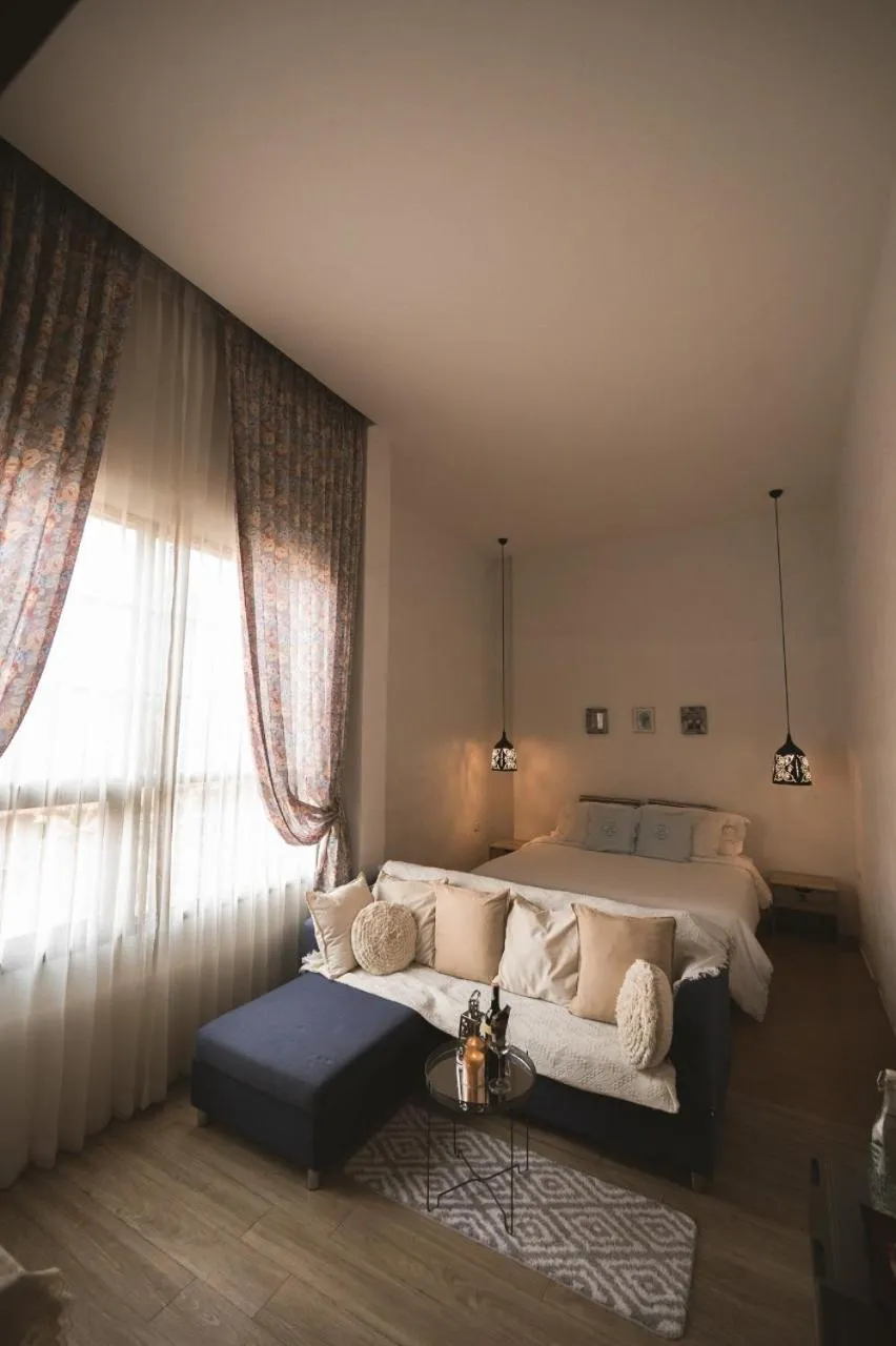 Bed in White Wall Riverfront Hotel