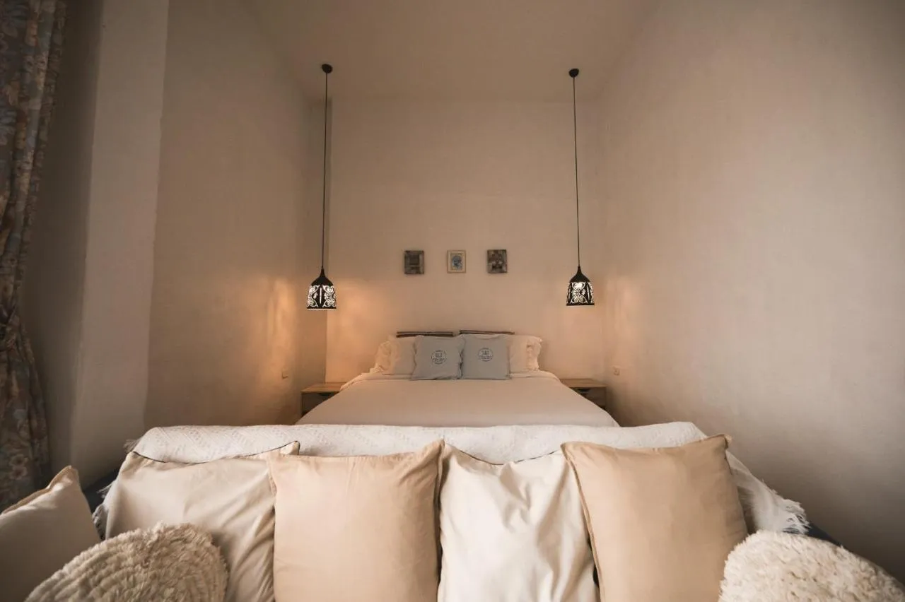 Bed in White Wall Riverfront Hotel